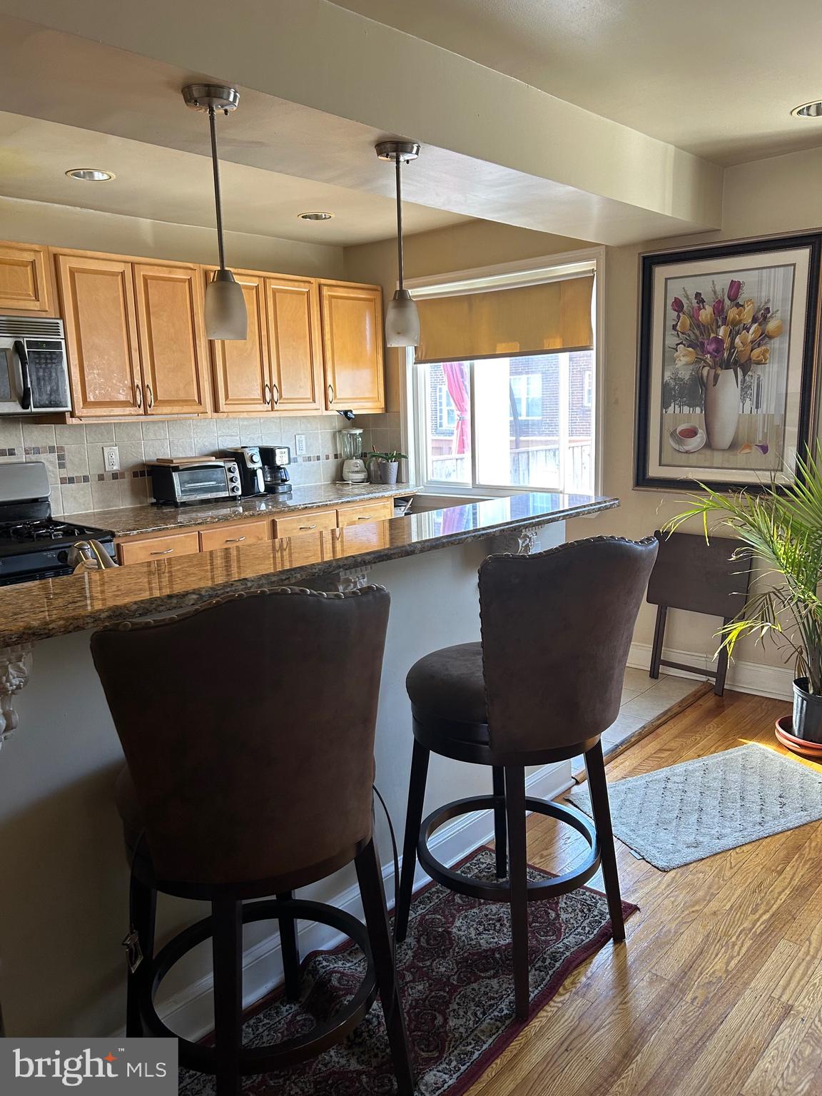 Beautifully kept townhome has so much to offer. Covered front patio. Living room entrance to an open space for entertaining, hardwood floors that continue to the dining room. Plenty of natural light in the rear of the home. Open kitchen breakfast bar to the updated kitchen. Granite countertops, stainless steel appliances and large open picture windows. The upper level boasts three great size super clean bedrooms and a full bath with skylight. The lower level has a finished room, half bath and hallway to the heating/ cooling and water heater. Door that leads outside and also a door that leads to the garage. The central air was installed in 2023. Large driveway for added parking and close to the corner for additional parking. This house is a winner!