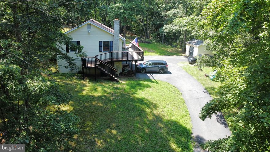 Nestled on a serene, wooded one-acre lot with no restrictions, this spacious 3BR/2BA home offers privacy, comfort, and versatility. The main level features a bright kitchen, dining room, and a cozy living area perfect for relaxing or entertaining. A full, finished basement provides additional living space, ideal for a family room, home office, or recreation area, complete with a wood stove for those chilly evenings. Step outside to enjoy the peaceful setting from the large deck, great for grilling, gatherings or enjoy your quiet evenings overlooking the trees. The outdoor space is complete with a fenced yard for your pets or kiddos, an above-ground pool for summer fun, along with a large storage shed. The attached 2-car garage adds convenience and extra storage. Whether you're seeking space for hobbies, animals, or simply room to roam, this property offers the freedom to make it your own and the privacy to get away from it all. Please see attached documentation for a list of items that have been updated and added and don't forget to look at the fall foliage pictures so you can see the beauty that is yet to come. Don't miss out on this peaceful retreat and the opportunity to enjoy country living with the benefits of a full-featured home. Schedule your tour today!