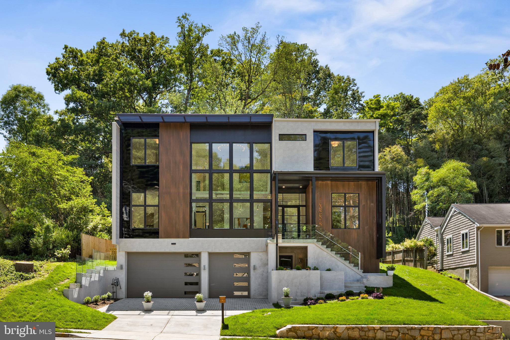 A Singular Masterpiece in North Arlington—Innovation, Luxury & Legacy
Step beyond the ordinary into the extraordinary. 3554 Military Road is not just a home—it’s a declaration. A triumph of modern design, this architectural jewel redefines what’s possible in North Arlington. Sited on a rare, tranquil third-acre lot and delivering over 7,100 square feet of bespoke luxury, this is a one-of-one opportunity. Homes of this caliber simply don’t repeat.
Architecture Without Apology
From your first approach, the home speaks with presence. A bold covered porch and 11-foot steel-and-glass pivot door open to a soaring 25-foot gallery-style living room, wrapped in floor-to-ceiling Marvin windows that flood the space with natural light.
The main level stuns with 12’4” ceilings, wide plank white oak flooring, glass railings, and oversized 8’ doors, combining volume and elegance in equal measure.
Entertain in Style
The flow is seamless and intentional. A nearly 20-foot dining room—among the largest at this price—anchors the main level, while a great room with 16-foot sliders opens to a covered loggia, blending indoor-outdoor living.
A main-level guest suite and a true executive office with pool views add everyday functionality and refinement.
A Kitchen that Commands Attention
At the center is a showstopping kitchen with sleek Porcelanosa cabinetry, quartz waterfall island, and a full suite of Miele appliances. A walk-in pantry with over 120 feet of storage, concealed lighting, and premium fixtures ensure nothing was overlooked.
Primary Suite Perfection
Upstairs, a vaulted 13’ ceiling, skylights, and glass balcony with pool views transform the primary suite into a sanctuary. The spa-inspired bath features dual floating vanities with LED lights, a curbless wet room with soaking tub, and 4’x4’ tiles for a seamless, luxe finish.
Dual walk-in closets feel like designer boutiques—fully outfitted with glass doors, LED lighting, jewelry drawers, and custom built-ins.
Designed for Real Life
Each upper bedroom is a private en suite with floating vanities, walk-in closets, and curbless showers. The laundry center features front-load appliances, built-ins, and a walk-in linen closet.
Lower Level. Limitless Potential.
Filled with natural light, the lower level includes a guest suite, fitness room with glass doors, and mudroom with high-end Salice system. A 3-car garage with 10’ doors and massive storage area—large enough for two cars—complete the space.
Your Private Resort
Step outside to a heated pool and jetted hot tub, a climate-controlled outdoor pool bathroom, and a spacious loggia. Permeable pavers, rainwater retention, and fiber cement + composite siding reinforce the thoughtful design and sustainability.
An Unrivaled Location
Just minutes from Georgetown, Downtown DC, Tyson’s Corner, Reagan Airport, and Amazon HQ2, this home sits in one of North Arlington’s most exclusive corridors. With top-tier schools, parks, and trails nearby, lifestyle meets legacy at every turn.
Not Just a Home—A Modern Legacy
3554 Military Road is a rare fusion of form, function, and forward-thinking design. If you’ve been waiting for the one—this is it.
Schedule your private showing today. Live modern. Live boldly. Live here.