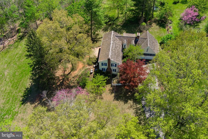 One of Kimberton's most charming properties!!!  This enchanting, sun-filled ​home, nestled on .80 acres adjacent to pr​eserved open space, walkable to Kimberton Village and mere minutes to vibrant downtown Phoenixville, is loaded with gorgeous vintage, architectural details​ that exude character and make a house a home.  Mature sentry trees dot the property, including a gorgeous red maple alongside the brick pathway that leads you through the fenced​ garden to the main entrance.  An abundance of windows on all sides of the home create incredible sunlit spaces throughout the day, starting with the living room.  This gracious  22' x 19 ' space includes the first of three wood-burning fireplaces, crown molding, wainscotting and windows on three sides.  Access the generous eat-in kitchen via either side of the main stairway, with lovely bump-out bay window framing the eat-in portion of the space, along with efficient cooking, prep and storage areas, including a large built-in hutch and a 7' x 7' pantry that could easily transform into a scullery. The main level powder room is also accessed from the kitchen, as are the Brazilian hardwood deck areas - amazing spots to enjoy the sights and sounds of nature. Back inside, French doors separate the eat-in kitchen from the truly stellar dining room, with large wood-burning fireplace, oversized windows with garden views, and plenty of room to host all your gatherings.  Take the back stairs from the dining room up to the great room, a super flexible living space that could be well-utilized as a playroom, studio, media room - use your imagination!!! The great room also accesses one of the four upper level bedrooms, a charming space that includes the third wood-burning fireplace, along with built-ins and closet storage, ideal for alternatively utilizing as a home office.  Down the hallway, find two additional bedrooms and a full hall bath with tub/shower combo, as well as the primary en-suite bedroom, with two closets and attached stall shower bath.  Laundry facilities are located in the walk-out basement area, which has been professionally waterproofed with a warranty that conveys with the house forever.  The basement is divided into two spaces - one housing the home's mechanicals - including a highly efficient, top-of-the-line geothermal heating and cooling system - the other a large 16'x36 foot finishable space that is all ready for a woodstove. From there, a second basement stairway leads directly to the attached, oversized two-car garage with copious storage.  Need more storage? Outside, a 14' x 18' shed provides great space for all your lawn and gardening tools.  This idyllic, one of a kind property imparts a feeling of privacy that will connect you with nature, yet provides all the conveniences of proximate shopping (Kimberton Whole Foods is blocks away!) along with easy access to the region's major thoroughfares and Paoli's train lines to Philadelphia, NYC and DC.  Come experience all this unique and magical property has to offer !!!