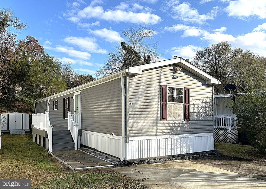 Beautiful 2 Bedroom, 2 Full Bath Single Wide in Sought After Wayson Woods MHC! This Home Features an Open Floor Pland with Gleaming Hardwood Floors Throughout the Living Room, Kitchen and Primary Bedroom. Enjoy Preparing your Meals in the Spacious Eatin Kitchen with Upgraded Stainless-Steel Appliances. and Breakfast Bar Peninsula. Large Primary Bedroom with Private Bath, Builtins and Custom Closet. Outside is a Custom Composite Front Deck, Shed, Patio and 2 Car Driveway. Community Perks Include Tot Lot, Basketball Court, Picnic Area and Boat Ramp. Close to Schools, Parks, Shopping and Restaurants. Just 20 Minutes to Andrews AFB and 30 Minutes to Downtown Annapolis. Don't Delay, this Beauty won't last!