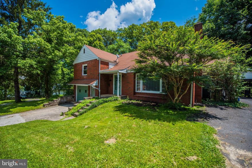 Cozy  Brick Bungalo--on 1.89 acre with public water and sewer,three bedroom  one and a half baths, hardwood flooring, car port & single attached garage, screened porch and large private patio along paved road close to the historic town of Berkeley Springs WV.