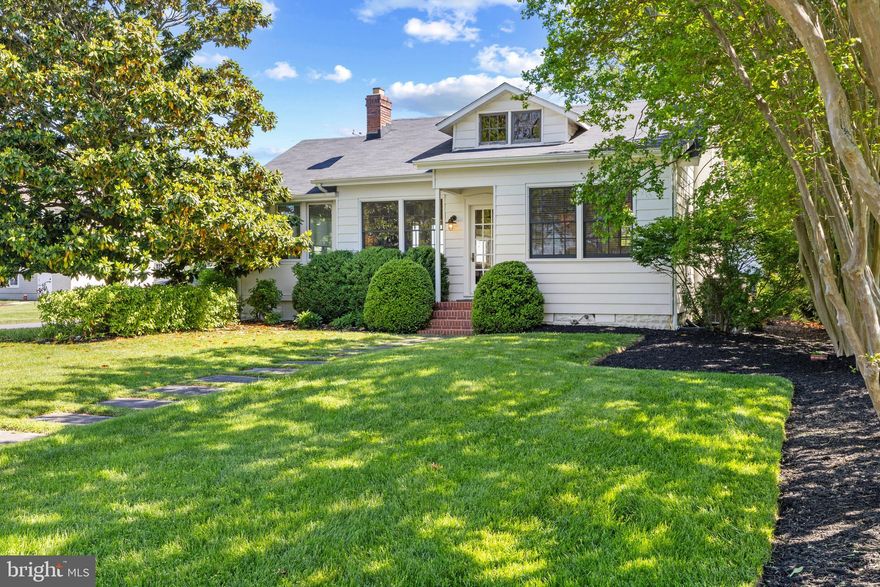 A comfy coastal cottage just steps from Lake Ogleton and Chesapeake Bay in the coveted Bay Ridge community. The interior gleams with hardwood floors, charming built-ins, cozy brick fireplace and stylish finishes throughout. The floor plan features an amazing gourmet Kitchen with dark countertops and modern white cabinets. The visually pleasing design coupled with the high end appliances and tons of natural light are sure to please everyone. The Living room with fireplace, sitting area/office and dining room create a wonderful space to gather and the expansive back deck ensures there is plenty of room for alfresco dining and enjoying the outdoors. 2 spacious bedrooms share a well appointed bathroom with beautiful tilework and walk-in shower.  The studio space attached to the detached garage provides additional square footage with large open room, kitchenette and full bathroom Perfect for family, guests or whatever suits your needs. Enjoy fishing, swimming, kayaking and heading out on the water from the community access just a block from the home or the community marina. Enjoy the waterfront lifestyle and feel like you are on vacation every day! The sought-after Bay Ridge Community features a community pool with a clubhouse that overlooks the beautiful waters of the Bay, community beaches on both the River and the Bay and a community Marina with a newly renovated clubhouse. Off-the-water activities include enjoying the basketball court, playground, ball fields, pickleball courts, common areas and year-round community activities. Walk or ride your bike for miles along the water and enjoy all the benefits of the Bay Ridge lifestyle, there is no other place like it! Located just minutes from downtown Annapolis and Eastport which offer the perfect balance of small-town charm and big world sophistication. Traveling or commuting is just as convenient by easily accessing Rt. 50 and 97 which provides direct access to Baltimore, BWI, Ft. Meade/NSA and Washington, DC., or head over the Bay Bridge to the Eastern Shore for a quick beach vacation. Don't let this one slip away!