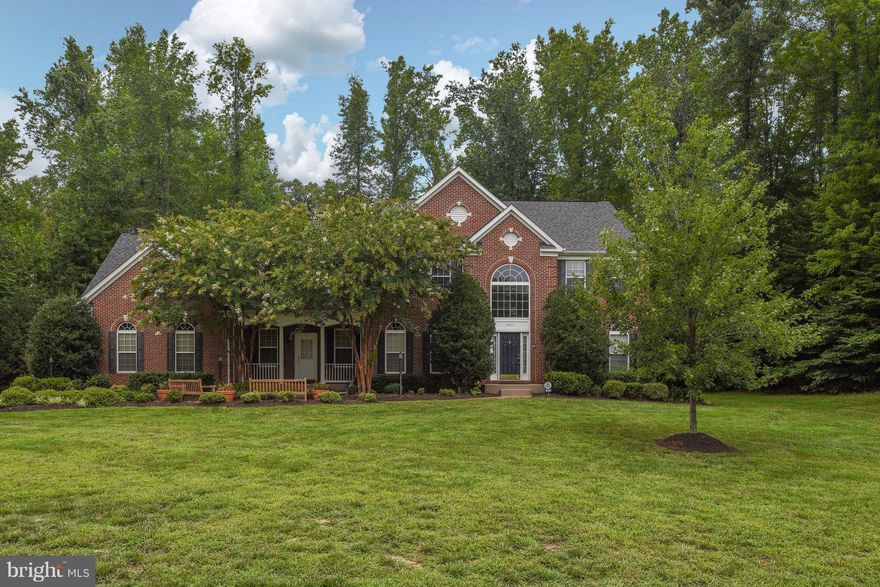 Stately Colonial with Stunning Open Floor Plan  6900 sq ft of Luxury. This former Model Home has Custom Features Throughout. Exquisite Trim Detail, Gourmet Kitchen, Dual Staircase, Sun room, Library, Lavish Owners Suite w/gas fp, Sitting Room and Luxury Bath. LL is perfect for Entertaining, w/Exercise rm, Rec Rm, 5th br (NTC) & full bath. 3.1 acres. 3 CAR GARAGE. Min to Marina,VRE, I-95& hospital.