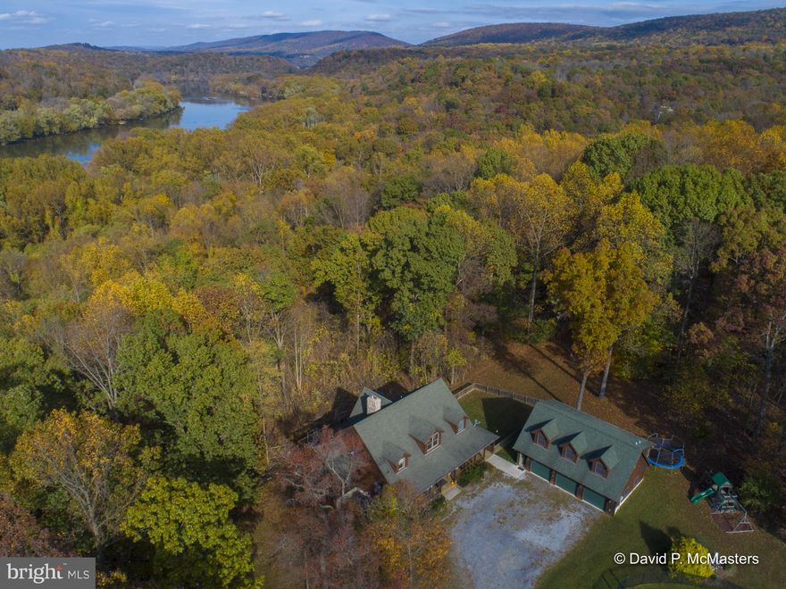A FABULOUS 32.7 Acre Shenandoah Waterfront property , CONSISTING OF 3 ADJACENT LOTS WITH A TOTAL OF 1800 LF  OF SHENANDOAH RIVER FRONTAGE. HIGH SPEED INTERNET WORK FROM HOME  THE MAIN 18.77 ACRE LOT IS BEAUTIFULLY IMPROVED WITH  a  5 bedroom  contemporary cedar HOME, A  2 STORY  3 car GARAGE WITH A  separate full APARTMENT ABOVE AND  A COMPLEX COMPRISED OF AN IN-GROUND POOL, POOL BUILDING, 1521 +- interior SF  WITH a handsome   REC ROOM , KITCHEN, Full Bath, changing room,  HVAC, CONNECTING  T0 A 3200 SF 2 LEVEL utility building,/ commercial garage, storage / workshop w full bath, multiple entrances;    2 OVER HEIGHT OVERHEAD DOORS and one  REGULAR GARAGE DOOR.  Plenty of room and space to  store your boat  and  all kinds of recreational equipment; i.e. trucks, rvs, 4 wheelers.    Additional  TWO LOTS, Lot ( 1),  5 acres,  Lot (3), 8.96 acres borders community pond,   ALL three HAVE RIVER FRONTAGE .   West Virginia LOW TAXES( There are three separate tax records for these properties; this listing system does not allow all three to be entered -- the total yearly  tax entered for all three is  $4998.36).   Property is unrestricted.  Please view our TWO VIDEOS and Multiple Documents (they include floorplans),   Property has HIGH SPEED INTERNET - Work from home There are 3 kitchen kitchens and 6 bathrooms in the entire complex.   SPECIAL FEATURES OF HVAC SYSTEM VERY IMPORTANT IN the PRESENT ENVIRONMENT: 1. UV light treatment - all return air is treated and kills any viruses in the air 2. HRV outside air ventilation- outside air is being brought in, warmed and mixed in with the inside air whenever the unit is running; fresh air is constantly provided.   ALL OF these ATTRACTIVE  BUILDINGS  ARE VERY WELL BUILT, high quality construction AND SUITED FOR A MULTITUDE OF USES.  Set up to have recreational  fun and bring friends  and family in a very private yet convenient setting of natural beauty .  1/2 hour to Leesburg, Virginia,  20 minutes to Marc Commuter train in Harpers Ferry,    EZ  Commute to the metro areas DC and Baltimore,  to Frederick, Md and Winchester, VA.   THIS COULD BE A GREAT FAMILY COMPOUND, A HUNTING/BOATING LODGE, AND PARTS WOULD MAKE GREAT WORKSHOP(S),  AIR B&B, Great Outdoor School for Kids, OR JUST YOUR OWN PRIVATE RESORT.    This property is not in a subdivision and is UNRESTRICTED.  Truly  rare, exceptional property near the Historic National Harpers Ferry Park.