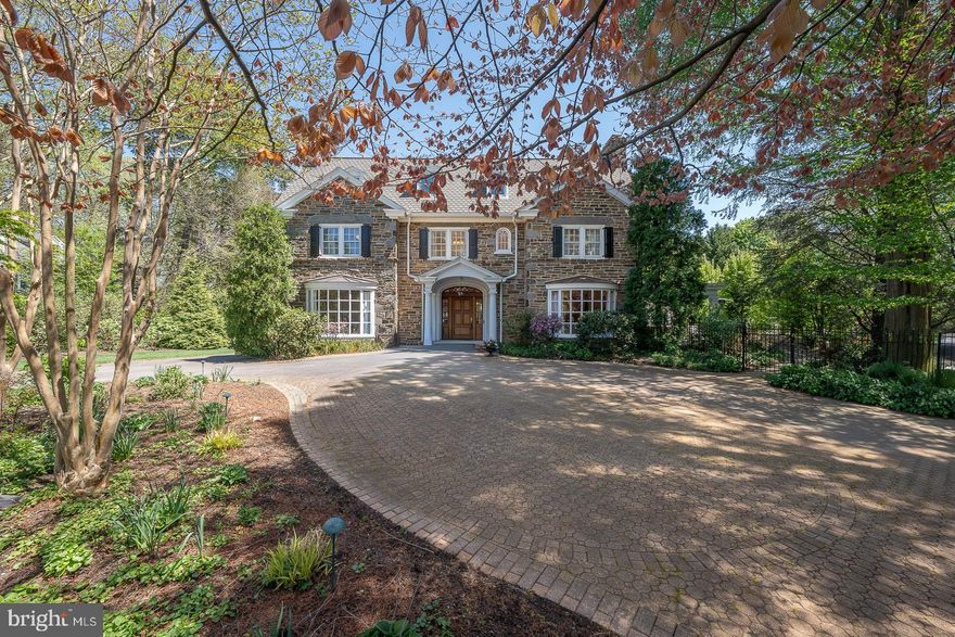 Welcome to 411 Wister Road in desirable Wynnewood, an extraordinary estate offering the perfect blend of timeless elegance, modern luxury, and resort-style living. Set on beautifully landscaped grounds with mature plantings, this exceptional property is a true private oasis, complete with a stunning in-ground heated pool, a fully outfitted pool house, and a detached four-car garage with a charming one-bedroom guest apartment. A grand marble foyer greets you upon entry and provides a breathtaking sightline straight through to the spectacular rear addition. The heart of the home is the impressive chef’s kitchen and sitting area, highlighted by soaring two-story exposed stone walls, oversized windows, and skylights that flood the space with natural light while showcasing picturesque backyard views. The kitchen features top-of-the-line appliances, an expansive island, quartzite countertops, and a sunny breakfast area, ideal for both everyday living and entertaining. The formal living room exudes sophistication with hardwood floors, a gas fireplace, window seat, custom built-ins, and exquisite millwork, seamlessly flowing into the adjacent family room. Double doors open to a stunning glass conservatory, perfect for relaxing year-round, which leads to a slate-covered porch with a wood-burning fireplace overlooking the pool and grounds. The elegant formal dining room, complete with its own fireplace, is complemented by a butler’s pantry and convenient back staircase and half bath. Upstairs, the luxurious primary suite offers a peaceful retreat with a gas fireplace, a spacious sitting room or optional additional bedroom, multiple walk-in closets, and a spa-like ensuite bath featuring a double vanity, separate makeup area, soaking tub, and oversized walk-in shower. Two additional bedrooms with built-ins and a full hall bath complete the second level. The third floor provides exceptional flexibility with a guest or au pair suite with full bath, plus three additional bedrooms and full hall bath. The finished lower level expands the living space with a large media and recreation room featuring a gas fireplace, built-in bookcases, and a bar area, along with a home gym, laundry room, mudroom, storage, and direct access to the backyard. Outdoors, the property truly shines. The pool house with retractable doors is designed for seamless indoor-outdoor living and includes a full kitchen with island, outdoor grilling station, dining area with pergola, lounge space, changing room with half bath, and additional storage. The expansive, private yard offers the perfect setting for entertaining or enjoying peaceful everyday living.  Additional highlights include a circular driveway, abundant parking, multiple storage areas including a landscaping shed, and a beautifully appointed one-bedroom guest apartment above the detached garage—ideal for visitors, extended family, or additional income potential. 
Located within the award-winning Lower Merion School District and walkable to Ardmore and Suburban Square, Narberth, Starbucks, Whole Foods and Septa Regional Rail,  as well as convenient access to Center City and major roadways, this one-of-a-kind residence is truly a must-see!