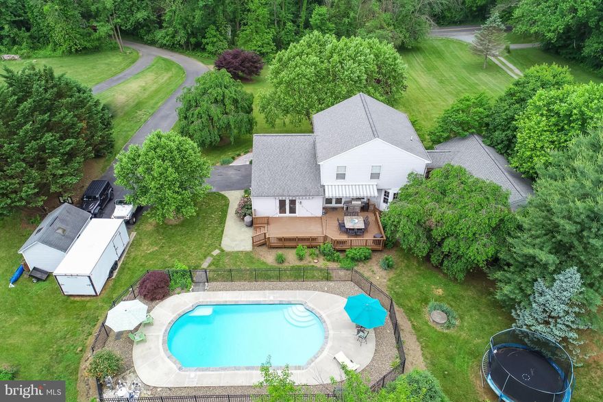 An amazing home in a great location perfect for today's modern family living.Lovingly cared-for home has updates galore! Freshly painted and new baths. Amazing back yard with in ground pool and spacious deck. Guest house w/large bedroom and full bath. Tankless water htr in house, guest house. Electronic fence. Riding mower, snowblower convey. Generator trans. switch. Fios. This house has it all!