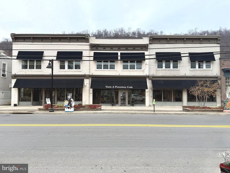 Presenting a premier mixed-use investment opportunity located in the heart of downtown Berkeley Springs. This historically significant building, spanning approximately a quarter of a city block, is positioned directly across from the courthouse. A well-known local landmark, the property was previously home to Tari's Cafe, a prominent restaurant and bar. This building has recently been renovated and boasts new roofing, siding, windows, HVAC, and the inclusion of the upper level apartments and short term rental rooms. The establishment is fully equipped and operational, ready for immediate use with all trade equipment included. Simply bring your menu and hire your staff to start serving. The property features a sizable storage area on the upper level, stocked with additional catering and trade equipment, all of which is also included. In addition, the main level offers a prime commercial storefront, providing additional revenue potential. On the upper level, the building includes versatile residential spaces designed for generating cash flow. One section comprises an expansive 2-bedroom, 1-bathroom residence with a fully equipped kitchen, walk-in pantry, formal dining room, living room, family room with rooftop access, laundry room, entryway foyer, and sitting room. This space could serve as a residence for the owner or restaurant manager. Additionally, this side of the building includes four "bed and breakfast" rooms (Two 1BR/1BA's, and two 1BR/1BA with living rooms), making it an ideal candidate for vacation rentals given its central downtown location. On the opposite side of the upper level you will find three 1BR apartments. Berkeley Springs is renowned for its beautiful natural surroundings, historic spa with the largest open display of thermal water in the Blue Ridge, vibrant art scene, and the annual Apple Butter Festival, which has been a local tradition since 1973. The town attracts hundreds of thousands of visitors annually, making this an exceptional investment opportunity in a highly desirable tourist destination. Do not miss out on this unique chance to own a piece of Berkeley Springs’ charm. Schedule your private tour today.