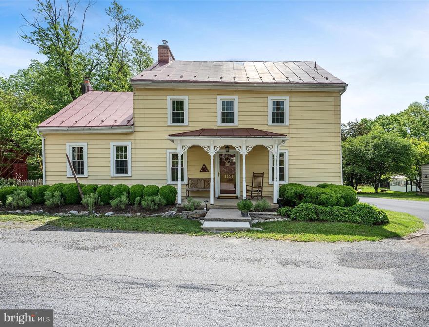 Imagine ending your day in the quiet charm of the Village of Middleway—this historic home on 0.76 acres sits at the heart of one of West Virginia’s most storied communities.

Relax on the generous covered porch as you look out over a flagstone patio, blooming gardens, and a fenced backyard that flows into an additional half-acre of lawn—ideal for quiet mornings, evening gatherings, or garden projects in every season.

Step inside to a warm, character-rich interior where wide-plank pine floors and a wood-burning stove anchor the main living room. A flexible family room offers space for gathering or a potential fourth bedroom, while the private study provides a tucked-away retreat. The dining room opens to a spacious kitchen with bamboo flooring, an island, historic built-ins, and main-level laundry. A mud room and half bath completes the first level.

Upstairs, three bedrooms share a full bath with a classic clawfoot tub. The unfinished attic offers room to grow if more space is needed.

Lovingly maintained and thoughtfully improved over the years, this home blends timeless character with modern convenience. Historic porches, original hardware, and a durable metal roof are paired with updated plumbing and electrical, and efficient two-zone heat pumps—offering comfort and confidence without compromising charm.

A large outbuilding on the property provides flexible space for a workshop, garden shed, or additional storage.