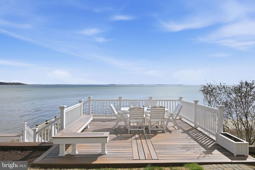 Set along a coveted stretch of the Chesapeake Bay, this exceptional waterfront residence offers a rare combination of sweeping panoramic views, a sandy, private community beach, and beautifully curated indoor-outdoor living. From the moment you enter, the home is defined by its connection to the water. Sunlight pours into the main living spaces, where expansive Bay views take center stage and create a serene, ever-changing backdrop. The flow from interior to exterior is seamless.  Step directly from the living room onto an expansive deck, ideal for elegant entertaining or quiet mornings by the water.

Beyond, a striking dual-level deck extends toward the shoreline, thoughtfully designed to maximize both perspective and privacy. Overlooking the sandy beach below, it offers an elevated setting for gatherings, sunset cocktails, or simply taking in the rhythm of the Bay.

Inside, the home has been refined with new flooring and lighting, creating a clean, sophisticated aesthetic that complements its natural surroundings. Meaningful upgrades—including a new deep well and a high-efficiency Mitsubishi climate control system—ensure both comfort and peace of mind. An EV charger adds a modern, forward-thinking touch.

Whether enjoyed as a full-time residence or a weekend getaway, this home offers a unique opportunity to own a piece of the Bay with exceptional views, direct beach access, and seamless indoor-outdoor living.