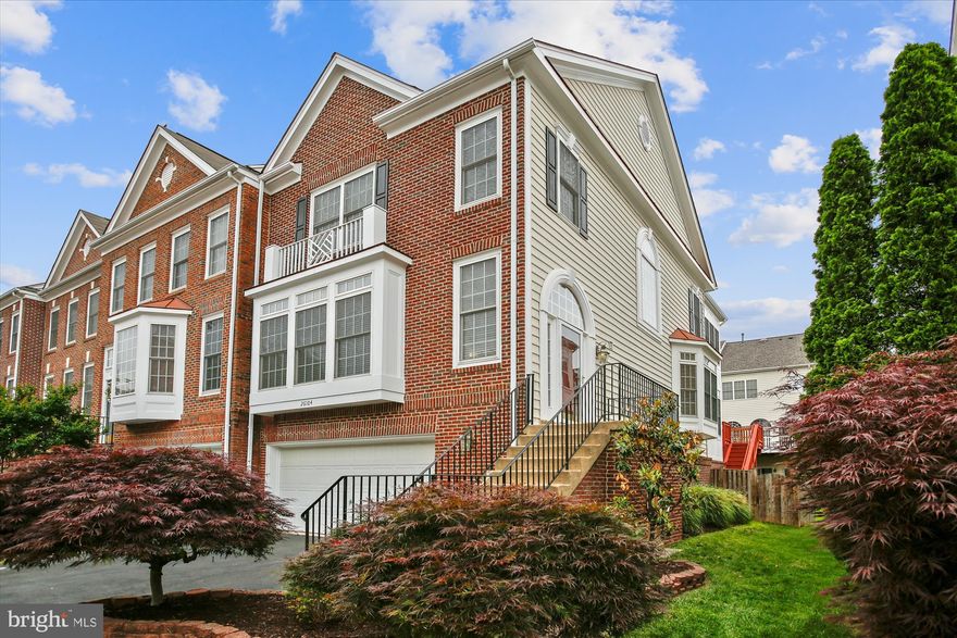 Beautiful end-unit townhouse with 3-story extension for incredible space and versatility. The side entrance welcomes you into the spacious living room with gorgeous hardwood floors and crown molding.  The gourmet kitchen features granite countertops, stainless steel appliances, buit-in microwave, recessed lights, pantry and a beautiful breakfast room with a bay window bump-out. Just off the kitchen is a sunroom with floor-to-ceiling windows and sliding glass door to the wrap-around deck, perfect for your morning coffee or evening wine. The primary bedroom boasts vaulted ceilings, a large walk-in closet and stunning sitting room with windows on three sides. The primary bath includes a dual-sink vanity, corner jaccuzzi tub and separate shower. The two secondary bedrooms each have vaulted ceilings and lighted ceiling fans. You will love the convenience of the bedroom level laundry closet. The lower level provides great additional living space and is highlighted by a gas fireplace and walk-out to the paver patio. All this plus a 2-car garage with extra storage and the exceptional ameniites of South Riding. Welcome Home.