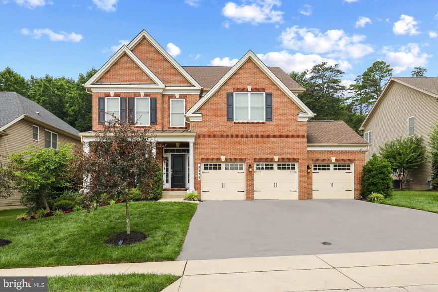 Welcome to an extraordinary residence in the sought-after Arundel Forest community, where sophistication, comfort, and convenience come together seamlessly. Set on a premier lot, this Toll Brothers Woodstock model makes an elegant first impression with its stately brick front and inviting covered porch. Inside a beautifully finished living space unfolds, designed to accommodate both grand entertaining and everyday living. A sunlit foyer opens to formal living and dining rooms, each adorned with gleaming hardwood floors, while a private study and main-level bedroom with full bath offer flexibility for guests or a home office. At the heart of the home, the gourmet kitchen is a chef’s delight, showcasing a granite center island with abundant storage, subway tile backsplash, deep stainless sink, and GE Profile appliances including a convection oven/microwave combo, 5-burner cooktop, hood, and dishwasher. The adjoining breakfast room flows effortlessly into the spacious family room with a cozy gas fireplace. From here, step onto the Trex deck and down to a flagstone patio, an entertainer’s dream for alfresco dining and gatherings. Thoughtful upgrades such as dimmer lighting, Nest thermostat, and central vacuum add convenience throughout. Upstairs, the primary suite is a private retreat, highlighted by a coffered ceiling, generous sitting area, oversized walk-in closet, and spa-inspired bath featuring dual quartz vanities, a jetted soaking tub, and an oversized rain shower with dual shower heads. Three additional bedrooms and a well-appointed hall bath with double sinks complete the upper level. The finished lower level offers even more space for relaxation and recreation, including a large open area, flexible playroom or potential sixth bedroom, and a full bath. Wide areaway doors fill the level with natural light, while ample storage space keeps everything organized. Blending timeless design with modern amenities, this remarkable home offers a rare opportunity to experience refined living in one of the area’s most prestigious communities. Perfectly situated near Fort Meade, BWI Airport, Columbia, Baltimore, and Washington D.C., this home offers an ideal balance of prestige and accessibility for today’s modern lifestyle. Residents of Arundel Forest enjoy resort-inspired amenities including a clubhouse, fitness center, pool, tennis courts, playgrounds, and scenic walking trails all just steps away.