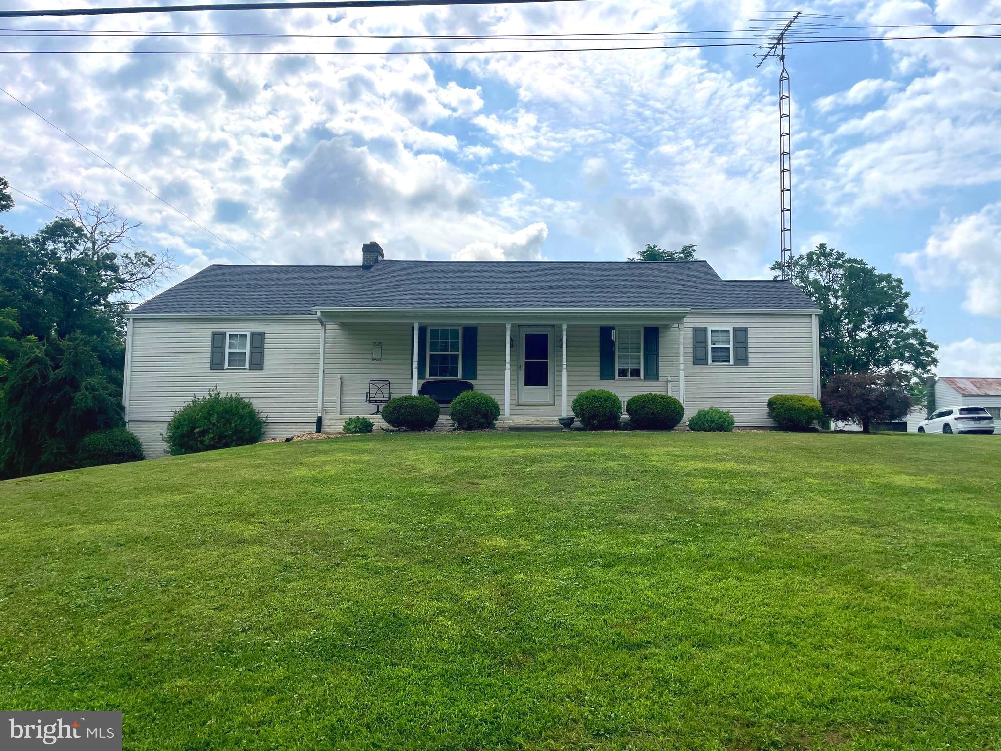 Welcome to 15 Ganotown East Rd.! Located in Back Creek Valley, this home sits on 2.567 UNRESTRICTED acres and has ample space to spread about with over 2,400 sq ft of living space, a full unfinished basement that could be turned into more living space or used as storage, a detached 3 car garage, and a pole building for any extra storage. As you enter the side door of the home, you are greeted with a formal living room. To the left you will find the kitchen and dining room. To the right of the formal living room you will find the half bathroom, a spacious family room with an office space off to the back, a sunroom that leads to a covered back deck, and then the laundry room and attached garage. Down the hall are two bedrooms with a hall bathroom as well as the primary bedroom with an attached primary bathroom. The attic could also be used for even more storage or possible finished living space. Outside you'll find a lovely open yard with a stream that runs through the property too! Don't wait to schedule a showing and take a look at all that this home has to offer! **TAX RECORDS SHOW FIREPLACE, THERE IS NO FIREPLACE OR WOODSTOVE** Sellers have recently sold some of the original land, the home is now on 2.567 acres** Sellers believe the original structure was built approximately 1956. The rest of the structure was built in 1998 per tax records.** Partial flood plain along creek.