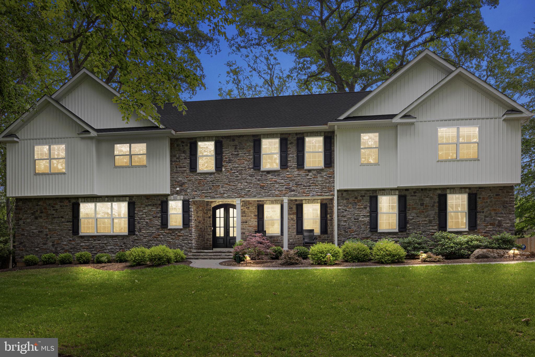 Nestled on over an acre of lush, tree-lined grounds, this stunning custom-built home offers the perfect blend of elegance and privacy. A long, private driveway winds through mature landscaping, creating a dramatic approach to the stately stone-front exterior. The facade showcases rich textures with stonework beautifully complemented by a covered front porch with classic columns—perfect for relaxing in a rocking chair and enjoying the serene setting. The grand double front doors with arched glass panes make an unforgettable first impression.
Step inside and prepare to be impressed by the bright and elegant interior of this beautifully designed home. The welcoming foyer showcases crisp white trim and wide-plank engineered hardwood floors. To the right, a sophisticated space is currently utilized as a home office, offering abundant natural light through oversized windows. With the addition of a closet, this versatile room could easily serve as a first-floor bedroom—perfect for guests or multigenerational living.
The open-concept layout flows effortlessly into a breathtaking two-story living room where soaring ceilings, floor-to-ceiling windows, and a cozy gas fireplace take center stage. This impressive space is ideal for both relaxing evenings and hosting gatherings, with sight lines that extend into the kitchen and dining area.
The chef’s kitchen is anchored by a massive 10 foot, seamless, quartz-topped island. It features white shaker-style cabinetry, stainless steel professional-grade appliances including a FORNO double oven and 8 burner gas range, a beverage fridge, and a deep farmhouse sink. The kitchen also offers a huge walk-in pantry, built-in microwave, and designer lighting that adds warmth and elegance.
Adjacent to the kitchen is a light-filled dining area perfect for casual meals, with sliding glass doors leading out to the expansive paver patio. For more formal gatherings, a separate dining room offers refined touches like custom wainscoting, crown molding, designer light fixtures, and a convenient bar area with wine storage.
Upstairs, retreat to the luxurious primary suite, featuring a spacious sitting area, a massive walk-in closet with custom built-ins, and a spa-like en suite bath. Here, you'll find dual vanities, a freestanding soaking tub, and an oversized glass-enclosed shower with dual shower heads.
A private princess suite includes its own walk-in closet and full bathroom, while two additional bedrooms—each with large walk-in closets—share a beautifully appointed hall bath. A second-floor laundry room adds convenience, while a catwalk-style hallway overlooking the two-story great room, enhances the home’s open and airy feel.
The finished basement expands the living space dramatically and is virtually staged to showcase its full potential. A large unfinished area—perfect for a home gym or storage—includes a private ramp leading directly to the garage, offering a separate entrance/exit for ultimate flexibility.
Step outside to the backyard and discover an expansive paver patio that provides space for grilling and entertaining—complete with a built-in retaining wall and surrounded by serene greenery for added privacy.
Ideally located in the heart of scenic Buckingham Township, 4245 Mechanicsville Rd offers the perfect balance of privacy and convenience. Nestled within the award-winning Central Bucks School District, this home is just minutes from historic Doylestown Borough, offering access to charming shops, dining, museums, and parks. Commuters will appreciate the easy access to Route 202, Route 413, and the Doylestown SEPTA station, providing a seamless route to Philadelphia and a direct connection to New York City in just under 90 minutes. Enjoy country living with city access in one of Bucks County’s most desirable and picturesque locations. Don’t miss the opportunity to own this exceptional property that offers the perfect blend of luxury, comfort, and convenience.