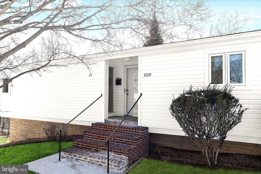 Experience a contemporary vibe in this just renovated 3 bedroom, 2 bath home with a new roof in the Pikesville Scotts Hill community. The open main level welcomes you with soaring vaulted ceilings, recessed lighting, modern neutral color palette and gleaming refinished hardwood floors that extend from the sun-filled living room into the dining area, where a built-in bookcase provides the perfect place to showcase your favorite décor.
Just beyond, the family room offers new plush carpeting, a cathedral ceiling, and a custom wood accordion door that allows the space to function as one expansive room or be divided into two separate areas such as a home office, den, or bonus room, adding exceptional flexibility to the layout. The on-trend renovated eat-in kitchen features new stainless steel appliances except for the refrigerator, a stunning custom granite countertop that blends beautifully with the cabinetry, and a custom herringbone backsplash that adds visual interest. A generous pantry provides abundant storage for kitchen essentials and more. The kitchen also has its own private entrance, making grocery unloading simple, while the adjacent deck creates an easy transition for outdoor dining and entertaining.
The main level sleeping quarters include the primary bedroom along with two additional bedrooms, all featuring refinished hardwood flooring, vaulted ceilings, custom-fit blinds, and access to a beautifully renovated full bath with a spa-like feel.
The finished lower level continues the living space with a newly carpeted recreation room and another private entrance that opens to a patio overlooking mature trees, offering both convenience and privacy. The updated bathroom showcases classic black and white tile flooring, ceramic tile walls, and an original ceramic tile feature wall that adds timeless character. Nearby, the spacious utility room includes laundry facilities and extensive storage.  Recent updates include a new hot water heater, and recently updated windows.  Plumbing and electrical permits in place.    With three separate entrances, flexible living areas, and distinctive architectural style, plus proximity to I-695, I-795 and under 2 miles to the Old Court Metro station, this move-in ready home delivers a true wow factor unlike any other.