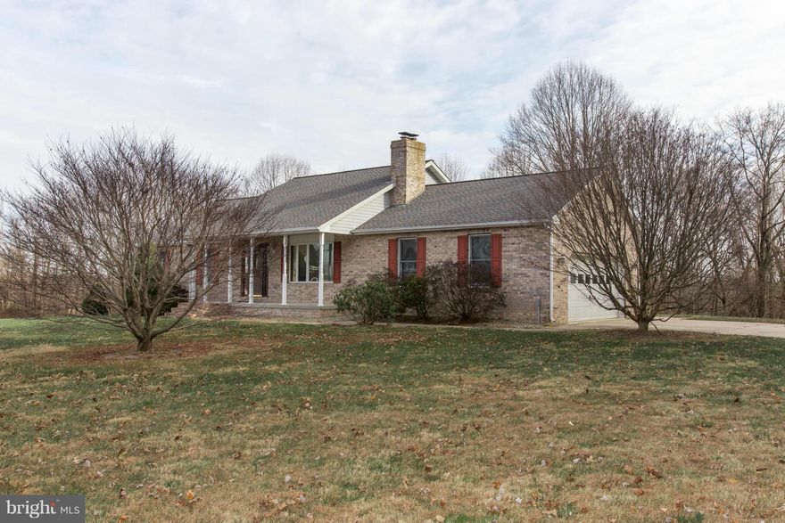 Stylish 3 BR brick rancher on beautiful 8 acre +/- lot. Long tree lined drive. Spacious living rm w/bay window and Brick fireplace. Dining rm w/French door opening to 26' x 16' rear deck. Kitchen w/handsome oak cabinetry, white appliances including Jennair range and porcelain sink. Owner's Suite w/bath. 2 car garage and additional 24'x24' detached garage w/electric. Would make a great shop.