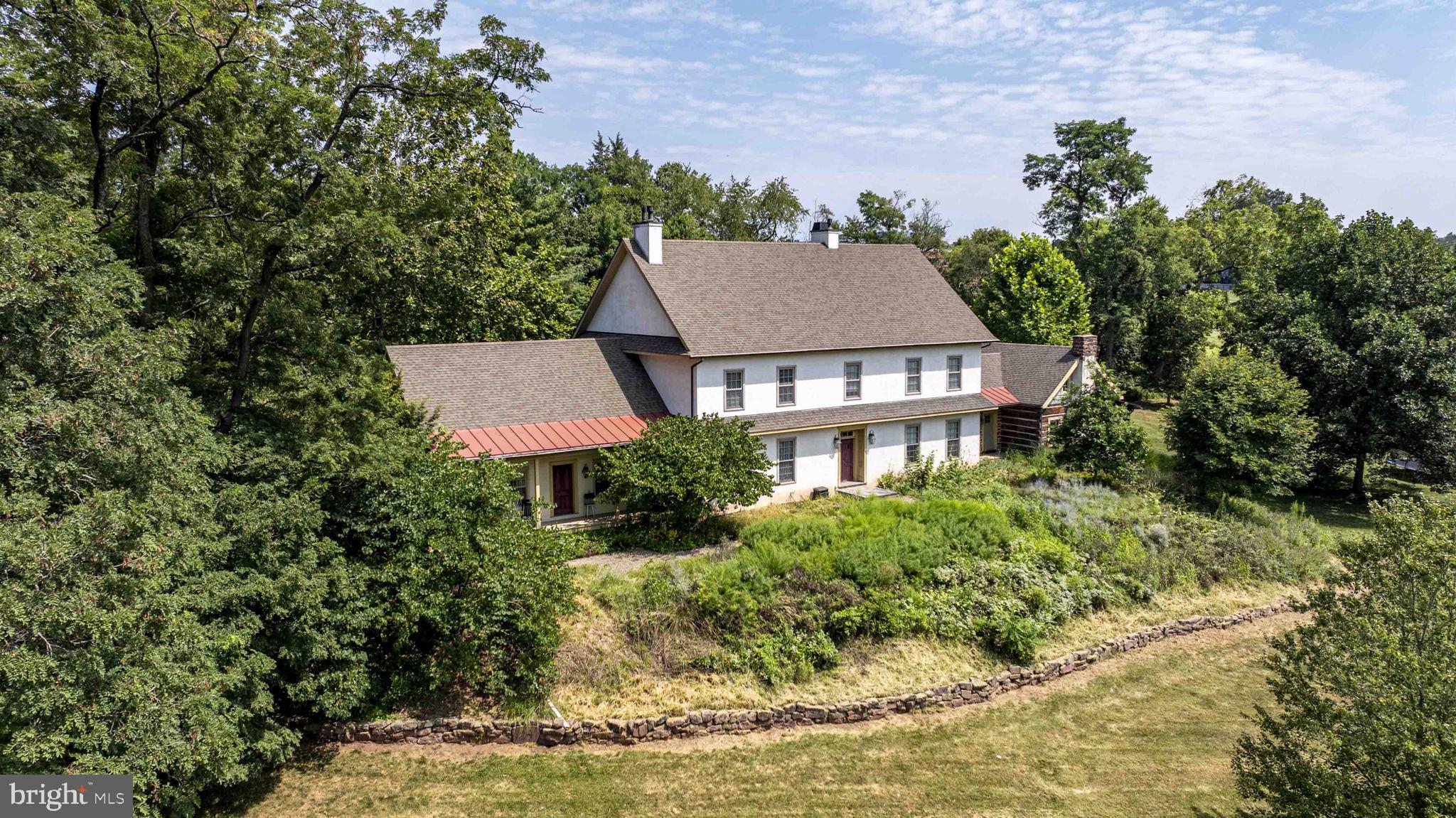 Tired of looking at cookie cutter homes? This is a once in the lifetime opportunity to have a reproduction farmhouse built in 2008 with all the modern amenities and modern construction but loads of character on 2.2 acres on a cul-de-sac in the desirable Spring-Ford Area School District. The craftsmanship of this home will amaze you! Enter the home through into the huge kitchen with 6 burner stove, 2 ovens, an abundance of custom cabinet, soapstone countertops, a walk-in fireplace and 2 butler pantries, The great room is a log cabin with a stone fireplace and cathedral ceilings,. The first floor also includes a sitting room with gas fireplace, a formal dining room with gas fireplace and an inlaw suite complete with a full bath and a walk in closet with laundry hook up. There is plumbing and electric to install a kitchen. The second floor features the primary suite that includes a huge walk-in shower, freestanding tub, double vanity, walk in closet and a water closet. Also on the 2nd floor are 2 large bedrooms each with a private bath. A laundry room with custom cabinetry completes the 2nd floor. The 3rd floor features 2 additional bedrooms, one of which has a private bath. 12" wide pine floors run throughout the entire home with tons of special touches to make this home extremely unique. The walk out basement runs the entire length of the home with tall ceilings, a fireplace and a rough in for a bathroom.. The recently redone 4 car detached garage features a bridge leading the 2nd floor with an additional garage door and extra storage. Don't miss out on this one!