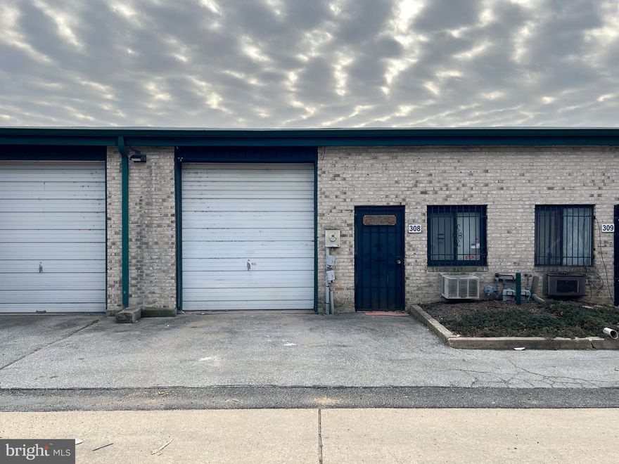 This high-utility industrial  warehouse unit offers an ideal footprint for trades, distribution, or artisan manufacturing, balancing professional frontage with a rugged, functional workspace. The entrance opens to a dedicated office and reception suite featuring custom cabinetry and a private half-bath, ensuring administrative operations remain distinct from the shop floor. The main warehouse area provides a heated environment with high-clearance ceilings and a high-lift overhead door to accommodate vertical storage or specialized equipment, and comes move-in ready with a utility sink, integrated shelving/storage, and a heavy-duty workbench. Adding significant value to the property is a private upper-level apartment at the rear, fully equipped with a kitchen, living area, and full bathroom, offering a rare live-work configuration or an expansive executive breakroom. The monthly condo fee is $125 which covers exterior building maintenance including roof and snow removal.  Shared parking spaces are available nearby. This versatile space is a sophisticated, affordable solution for business owners seeking a multi-functional home base for their operations.