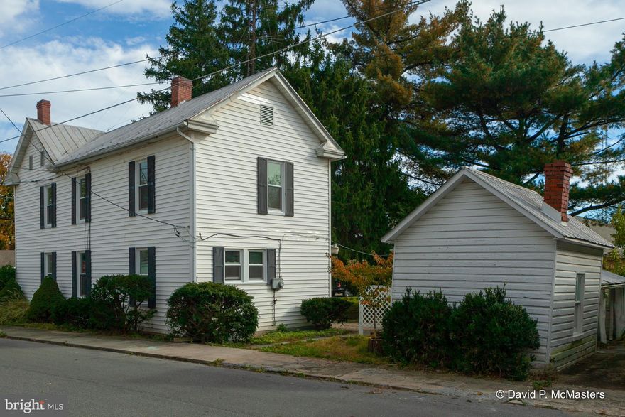 Restored home-move in ready-should go all loans.With the great features of a home this age: big baseboards,beautitul staircase, wood floors & lots of woodwork. New windows and freshly painted. Possible In-law suite upstairs with 2nd full kitchen & bath. Charming slate courtyard in back w/nice plantings (big magnolia tree) and a cute little shed w slate roof.   1 mile to MARC Train.Public bus The current taxes are for a rental/ investment property; this property will be eligible for a substantial tax reduction if purchased for residential use.  Seller will be installing a privacy fence along the front side yard of the house as soon as weather permits.