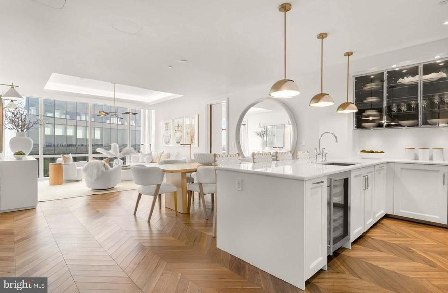 TWO BEDROOM + DEN/OFFICE AVAILABLE!
Welcome to the Four Seasons Private Residences in Harbor East, where luxury meets lifestyle in Baltimore’s most coveted waterfront address. This stunning two-bedroom, two-bathroom unit comes with a designated light-filled den/office and was thoughtfully designed to maximize every inch, making it live far larger than its 1,486 sq ft. Step into an atmosphere of sophistication with soaring ceilings, rich walnut chevron-patterned flooring, and curated designer finishes throughout. Expansive floor-to-ceiling windows flood the home with natural light and offer breathtaking views of the Inner Harbor and iconic Domino Sugar sign from every room. The open-concept living and dining areas flow seamlessly into a gourmet kitchen outfitted with Miele appliances, sleek Eggersmann soft-close cabinetry, luxurious marble stone countertops, and a built-in Sub-Zero wine fridge. The primary suite is a tranquil retreat, featuring two custom-built walk-in closets and a spa-inspired, marble-clad en-suite bath. Enjoy a double vanity with designer finishes, private water closet, glass-enclosed walk-in shower with a built-in bench and niche, and a sculptural freestanding soaking tub that invites total relaxation. The spacious den (accessible from both the guest suite and living room) provides flexible use as a home office, library, or media room, and every space is enhanced with expansive views that change with the light.

The Four Seasons Private Residences Baltimore offers a turn-key elevated lifestyle. As a resident, you'll enjoy a private entrance where you will be met by our full service concierge and on-site building manager to assist with your every need, as well as exclusive access to the sprawling 28th-floor amenity level, where world-class services meet resort-style indulgence. Amenities include an indoor heated saltwater infinity-edge pool, a state-of-the-art fitness center, sauna, coffee station, billiard room, and numerous elegant gathering spaces. Multiple rooftop decks offer panoramic city and harbor views, complete with indoor and outdoor fireplaces, a grilling station, a dining area, and a kitchen, all ideal for entertaining. Additional perks include a fully equipped conference room and a dedicated AstroTurf dog-walking area. This residence offers the rare opportunity to live within a full-service, hotel-branded building while enjoying the privacy and sophistication of a true luxury home. All set within steps of Harbor East’s acclaimed restaurants, shopping, and the waterfront promenade. This is a MUST SEE TWO BEDROOM + DEN!! Immediate occupancy is available. Come see what all the fuss is about!