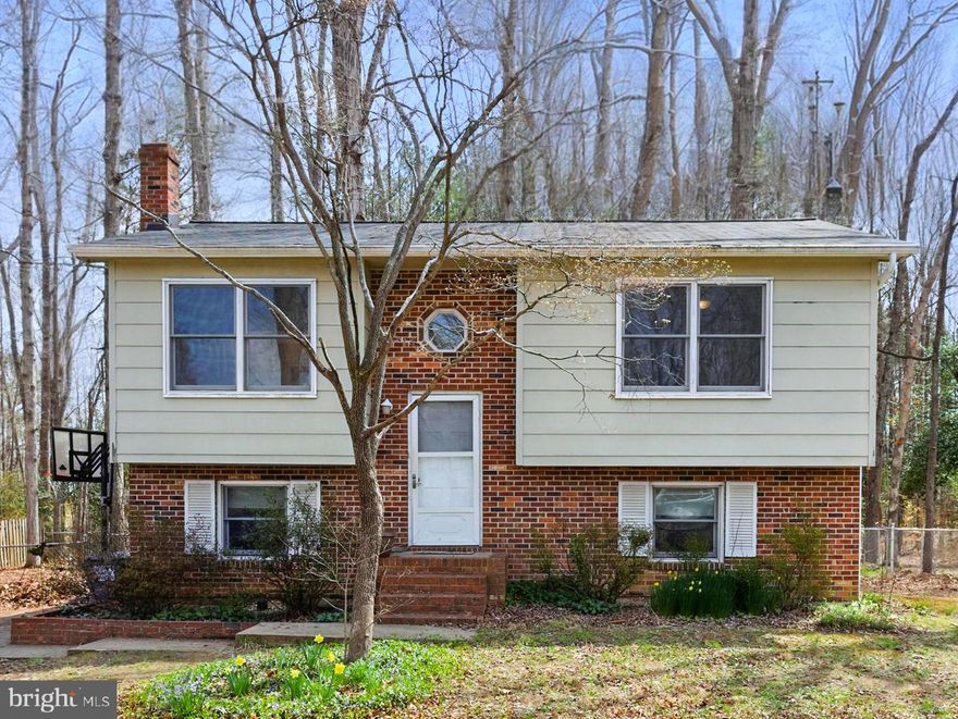 This lovely 4 bedroom split foyer is full of potential and offers plenty of space and wonderful features both inside and out. Located in Mill Garden South, here you'll enjoy easy access to nearby conveniences and amenities, in a quiet established neighborhood. Updated flooring and newer kitchen appliances have been added on the main level, and a brand new hot water heater was recently installed in 2024. The home is also equipped with updated tilting Andersen windows that allow for easy cleaning. The roof was replaced in 2018 for additional peace of mind. Upstairs you'll find two spacious bedrooms and a full bath, complete with a skylight, to add wonderful natural light while you're getting ready. Downstairs are two additional bedrooms, a flex recreational space and a second bathroom. You'll also find a conveniently placed laundry room on this level as well. The washer and dryer are top of the line and less than a year old. The back deck provides ample space for all of your outdoor entertaining needs, and stairs will lead you to your fully fenced in backyard.  Best of all, the spacious flat lot backs to trees, offering both privacy and a serene setting. This home is a blank canvas and a perfect opportunity for your vision to come to life. It is ready for you to transform it into the space you've always dreamed of.  Come see it for yourself and schedule your showing today!