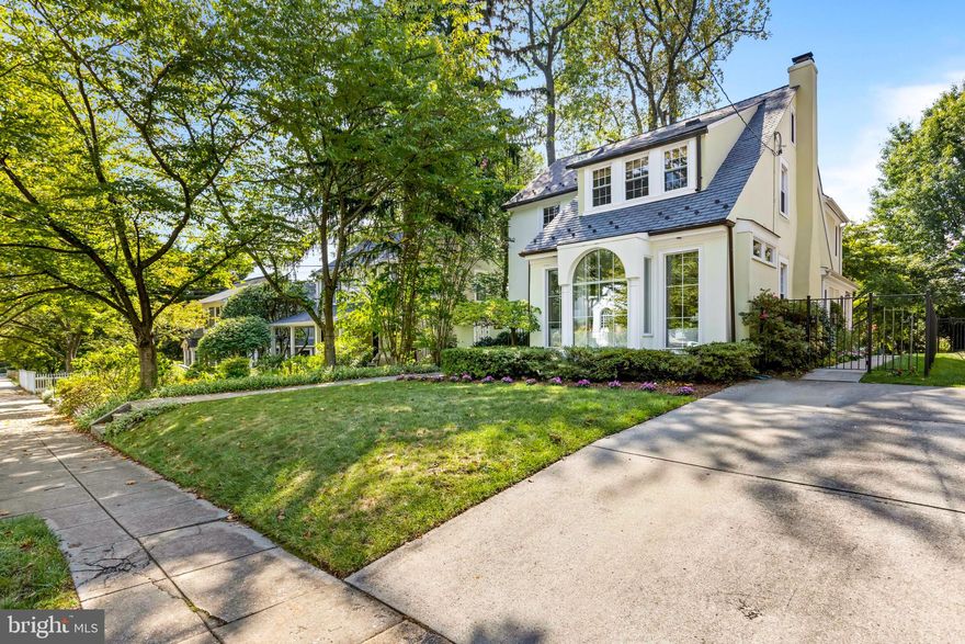 Introducing this impeccably maintained residence located in the heart of Wesley Heights. Boasting 5 bedrooms and 3.5 baths across an estimated 3,614 finished interior square feet, this captivating home seamlessly blends classic architecture with contemporary charm. The two-story addition at the rear floods the floorplan with natural light and high ceilings, creating an exceptionally spacious ambiance. The stucco and slate exteriors, paired with great curb appeal, welcome you into a generously lit interior with a great flow. Upon entering, you'll be greeted by gleaming hardwood floors, high ceilings, and oversized windows throughout. The main floor features a spacious living room with a wood-burning fireplace that flows into a large family room, a kitchen and formal dining room, a convenient office/den, and a sunroom with floor-to-ceiling windows and picturesque, tree-lined views. The expansive eat-in kitchen is equipped with professional-grade stainless steel appliances, granite countertops, custom cabinetry, and a charming breakfast nook. A powder room rounds out this level. On the upper floor, four generously sized bedrooms await, including a king-sized primary suite complete with an en-suite bath and a walk-in closet. A hall bathroom with a deep soaking tub completes this level. The fully-finished attic serves as a versatile 5th bedroom, featuring a large window, skylight, tree-lined views, and extra storage. The recently-finished lower level offers additional flexible space, a convenient full bath, and a spacious mechanical/laundry room with ample storage. This magnificent home is situated on an expansive lot, providing a tranquil retreat in the rear. It boasts a large flagstone patio with built-in seating, a hot tub, and a lush, tiered, fenced-in lawn adorned with mature plantings, offering ample space for entertaining or relaxing in style. Completing the package is a four-car carport at the front of the property. Ideally positioned on a serene, tree-lined street, this residence offers excellent walkability to popular establishments such as Starbucks, Wagshals, Chef Geoff’s, Al Dente, and all the offerings of Foxhall Square. Additionally, it's conveniently close to Battery Kemble Park, Glover Park, Tenleytown Metro, and much more.