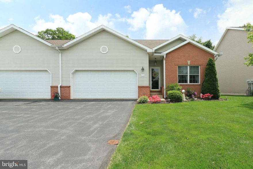 Prepare to Be Impressed—This Rosewood Cove Condo is a Total Show Stopper.  Experience the convenience of seamless single-level living in this beautifully upgraded condo, tucked away in the tranquil Rosewood Cove community on the outskirts of historic downtown Bellefonte. Located just off Blanchard Street & within than 2 miles from I-99, this prime location offers a quick commute to State College & Penn State University while enjoying a peaceful, tree-lined setting.  Inside, you'll discover an open-concept floor plan with gleaming hardwood floors throughout most of the main level. The inviting Great Room features a soaring vaulted ceiling, recessed lighting, ceiling fan & a cozy propane fireplace, perfect for both relaxing & entertaining. The adjoining dining area includes a sliding glass door that opens to an oversized tiered rear deck with a retractable awning, ideal for enjoying summer days & overlooks the private back yard.  The kitchen is as stylish as it is functional, boasting granite countertops, ceramic tile backsplash, crisp white cabinetry, a breakfast bar & comes complete with included stainless appliances.  There is a convenient laundry area, with included washer & dryer, a handy pantry & a door that provides direct access to the attached 2-car garage, making daily tasks a breeze.  The first-floor owner’s suite offers a vaulted ceiling, walk-in closet & a private full bath with tile flooring & a walk-in shower.  2 additional main-level bedrooms & a second full bath provide flexible space for guests or home office needs. Downstairs, the finished walk-out lower level adds a generous rec room with luxury vinyl plank flooring, third full bath & abundant unfinished storage space.  Additional features include central vacuum, a new HVAC system (2023), water softener & radon mitigation system. The low monthly condo fee covers exterior building maintenance, exterior insurance, lawn care, snow removal & refuse, making this home an ideal choice for those with a busy lifestyle or anyone looking to enjoy low-maintenance living in a serene setting.