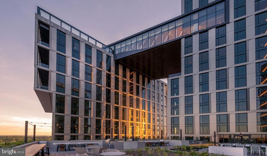 The Elm stands as one of downtown Bethesda’s most sophisticated residential addresses, redefining what it means to live well in the heart of a vibrant, walkable city. Rising high above Elm Street, this sleek glass and stone tower captures the energy of urban living while surrounding residents with the tranquility of beautifully crafted interiors and resort-inspired amenities. From its elegant architecture to its sweeping panoramic views, The Elm was designed to elevate every moment of daily life.

Inside, residences at The Elm embody timeless modernity and comfort. Expansive floor plans feature floor-to-ceiling windows that frame the city skyline and flood each home with natural light. The interiors are finished with premium materials, including wide-plank flooring, designer lighting, and custom cabinetry that complement the clean, contemporary lines of the architecture. Gourmet kitchens come equipped with high-end stainless-steel appliances, quartz countertops, and large islands perfect for entertaining or casual dining. Spa-inspired bathrooms showcase large-format tile, sleek fixtures, and walk-in showers or soaking tubs that make relaxation effortless. Many apartments extend outdoors with private balconies, inviting residents to unwind and enjoy open-air views of downtown Bethesda and the surrounding greenery.

The Elm’s amenities are curated to offer a lifestyle that is both indulgent and deeply connected to community. The building features a stunning rooftop pool and lounge that overlook the Bethesda skyline, ideal for sunny afternoons or evening gatherings. A fully equipped fitness center and yoga studio make wellness part of the everyday rhythm, while the indoor/outdoor clubroom, co-working spaces, and private conference rooms ensure residents can balance work and leisure with ease. For those who appreciate convenience, The Elm offers 24-hour concierge service, package management, secure parking, and pet-friendly spaces, including a dedicated dog run and grooming area. Every detail reflects the building’s commitment to modern living with an elevated sense of hospitality.

Living at The Elm means being immersed in the best of downtown Bethesda. Just steps from Bethesda Row and Woodmont Triangle, residents enjoy world-class dining, boutique shopping, and vibrant nightlife right outside their door. Local favorites like Mon Ami Gabi, Tatte Bakery, and The Barking Dog line the streets, while weekly farmers markets and outdoor festivals fill the neighborhood with color and community spirit. With direct access to the Bethesda Metro Station, The Elm also provides seamless connectivity to Washington, DC, and beyond—offering the perfect balance of urban excitement and suburban ease.

Future residents will love how The Elm captures the essence of contemporary Bethesda living. It’s a place where architecture, amenities, and neighborhood culture intertwine to create an experience that is dynamic, elegant, and authentically connected to its surroundings.

** Pricing and availability subject to change on a daily basis. ** Photos are of model units. ** If parking is an option, availability subject to change along with pricing. **