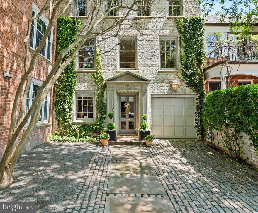 This elegant Georgetown townhouse combines historic character with sophisticated modern design. Once the residence of acclaimed designer Frank Babb Randolph, the home retains his signature aesthetic, further refined and updated with additional improvements. 
Discreetly set back from the street, the generous front garden with its granite cobblestones is a graceful entry into this magnificent residence. The formal marble foyer sets the tone for the home's luxurious interiors. A powder room is located just off the hall, which leads to a spacious family and media room on the lower level. This room opens directly to a beautifully landscaped brick terrace, surrounded by mature plantings and blossoming trees, providing an idyllic setting for outdoor entertaining and relaxed daily living. 
Upstairs, the second floor has been reimagined by architect Christian Zapatka to create an open, flowing layout with impressive proportions. The formal living room features soaring 13-foot ceilings, a fireplace framed by decorative alcoves, crown molding, and French doors that overlook the garden, filling the space with natural light. The adjacent kitchen, custom-designed by Jennifer Gilmer, is both sophisticated and highly functional, with handcrafted cabinetry, a large island with a Shaws farmhouse sink, Sub-Zero refrigerator and freezer, and a Thermador double oven. An expansive dining area flows seamlessly from the kitchen, perfectly suited for entertaining.
The third floor features a luxurious primary suite with lime-washed detail and views of the Washington Monument. It includes a generously sized walk-in closet and a recently completed Jennifer Gilmer spa-inspired bathroom with a dual vanity, custom lighting, ample cabinetry, and a multi-function frameless glass shower. Two additional guest bedrooms and a well-appointed hall bath complete the upper level.
With meticulously crafted interiors, exceptional architectural updates, and a sought-after location, this residence presents a rare opportunity to own a piece of Georgetown’s design legacy. A private garage adds convenience, while the home’s prime location, closely located to Georgetown’s renowned shopping, dining and parks, offers a desired balance of serene living and vibrant city access.