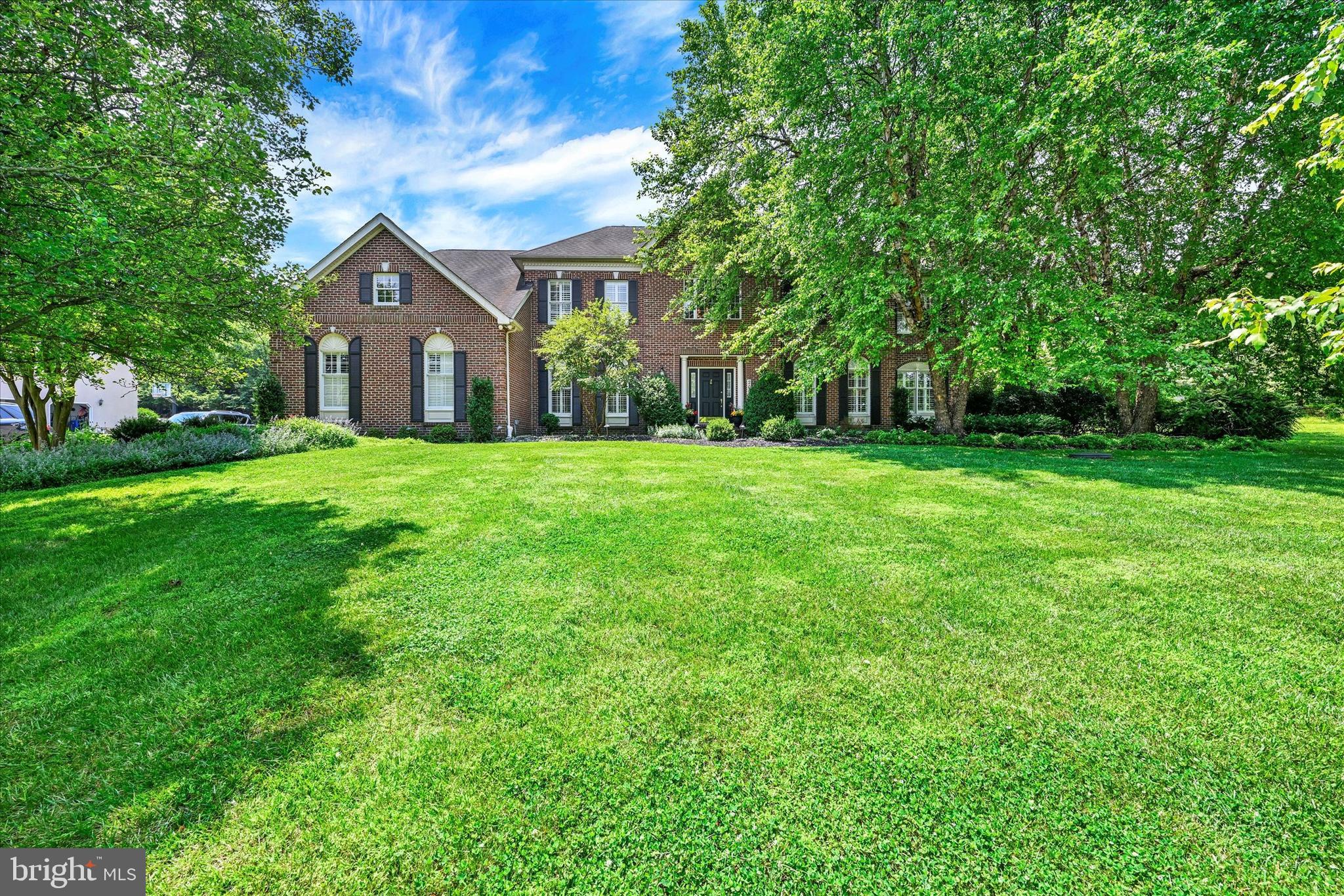 Opportunity Knocks To Own A Toll Brothers Home! You must see this well maintained one of a kind unique spacious 6 bedroom, 5 and 1/2 bath home over 6000sf of living space that boast a luxury private in-law suite on the main level with patio doors that leads to a porch surrounded by beautiful landscaping and trees. First step into the magnificent freshly painted home with 9ft ceilings and plantation shutters throughout that opens up to an elegant two-story foyer with a turned stair case that offers wide sprung decorative molding and a dramatic overlook in the front and rear of the home. The living room features wood floors, decorated columns, recessed lighting with plenty of natural light. The dining room offers wood floors, a tray ceiling, chair molding, and space to host large dinners for family and guests. The updated beautiful bright kitchen includes new wood flooring, updated lighting, new quartz counter tops and a custom backsplash, a nice island, a gas cooktop, double wall oven, stainless steel appliances including two new double stainless refrigerators a chef's choice, a butler's pantry, plenty of storage space and rear dual staircase. The oversized family room features a nice stone wood burning fireplace with a mantle that leads to an office or flex room. The main level also offers an expansive mud room with custom built-in shelving, new wood floors, and a washing area with a utility sink for convenience. The upper level offers 4 spacious bedrooms with new carpet on the floors and staircase. The upper level primary ensuite includes two nice walk-in closets with built-in shelving, a sitting room, a nice private bathroom with updated lights, a vaulted ceiling, dual sinks, a jacuzzi soaking bath tub with jets and a separate shower. The lower level features the 6th bedroom, an exercise room, an expansive recreation room with a nice kitchenette ideal for entertaining, and tons of storage space with more built-in shelves. This home has multiple heating and cooling systems. The exterior features includes a stately brick front with picturesque landscaping, an extended driveway with an oversized side loaded garage that accommodates three vehicles. The rear of the home includes a stunning custom brick patio in a tranquil setting, ravishing landscaping, a play set and a huge leveled lot for endless possibilities. This lovely home could be yours. Call and Schedule your appointment before it is too late!