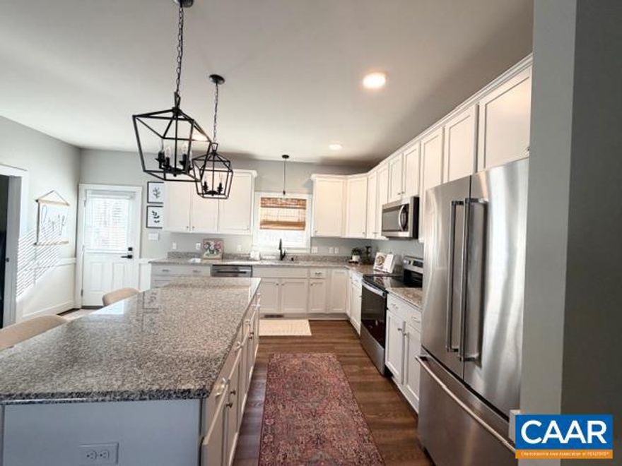 NEW, NEW, and more NEW define this impeccably updated 3 bedroom, 2 bath ranch offering effortless one-level living. Highlights include 9-foot ceilings, LVP flooring, a cozy fireplace, and exceptional Firefly high-speed internet ideal for gaming, multiple devices, and smart-home technology. The kitchen features all-new 2025 lighting with lantern pendants on dimmers, updated sink and can lighting, a NEW dishwasher, NEW woven wood shade, granite countertops, soft-close cabinetry, stainless steel appliances, a large island, and pantry. Additional 2024?2025 upgrades include a NEW dining room statement light, NEW living room floor outlet, NEW shiplap accent wall with dual closets in the 3rd bedroom, NEW MDF closet shelving in the 2nd bedroom, and NEW shiplap wainscoting in the full hall bath. The primary suite offers a HUGE walk-in closet and private bath. Oversized 2-car garage includes a NEW full-screen door, NEW cabinetry, bike hooks, kayak racks, workbench, and walkable attic. Exterior features include NEW generator hookup, NEW rear fencing, 1.5-acre lot, front porch, rear deck, conditioned crawl space, and ample parking. Convenient to Short Pump and Charlottesville.,Granite Counter,White Cabinets,Fireplace in Living Room