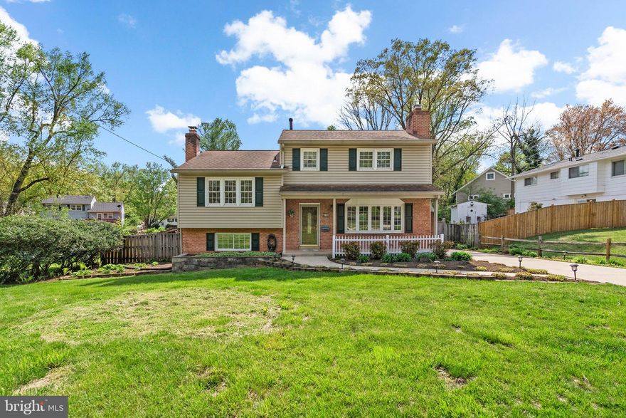 Charming and spacious home with welcoming front porch and beautiful wood floors throughout. Step into the light-filled living room featuring a large bay window, flowing into the formal dining room just off the fully equipped kitchen—complete with direct access to a large back deck, perfect for entertaining. The rear yard boasts lovely flower beds and a versatile outbuilding ideal for a workshop, exercise room, studio, or more. Upstairs, you'll find five generously sized bedrooms and two baths, offering ample space for everyone. Just one level down from the main living area is a sprawling family room with a cozy fireplace, a convenient half bath, a laundry room, and access to the backyard. There's also a separate recreation room. Ideally located near shopping, dining, entertainment, and major commuter routes—this home offers both comfort and convenience!