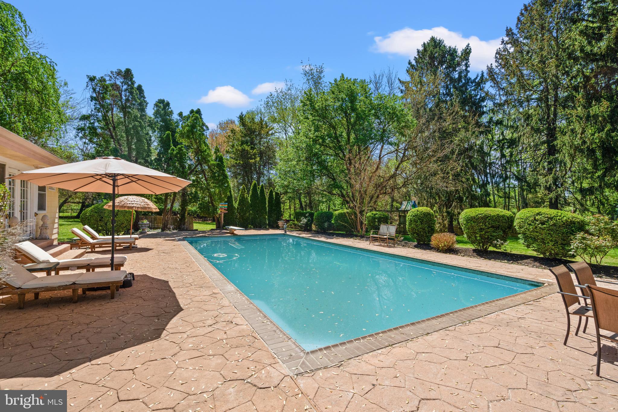 Welcome to Your Private Vacation Oasis — Right at Home! Step into pure serenity with this exceptional 3-bedroom, 5-bath retreat, with 4245 SQFT main living space , nestled on over 1.36 acres of beautifully landscaped, flat yard. From the moment you arrive, you’ll feel like you’ve stepped into your own private resort. Whether you're entertaining under the stars or enjoying a quiet morning coffee, this home is designed to be your year-round escape. The highlight - A stunning in-ground pool accompanied by a stylish pool house, which doubles as a one-bedroom in-law ensuite. This versatile space adds both fun and functionality—ideal for effortless entertaining or unwinding poolside. Multiple expansive decks offer seamless indoor-outdoor living, featuring a hot tub for relaxation, surrounded by blooming trees and lush gardens that burst with color throughout the seasons. Inside, the home is just as impressive. The cathedral ceiling in the living room, anchored by a dramatic stone wall and fireplace, creates a warm and inviting centerpiece with a true wow factor. A total of three fireplaces throughout the home provide an unmatched cozy ambiance—perfect for quiet nights in or festive winter gatherings. The large eat-in kitchen, adorned with the great room, offers plenty of space for casual dining and conversation, while the separate formal dining room is ideal for hosting elegant dinners or holiday celebrations. Each space is thoughtfully designed to blend comfort and sophistication with gleaming hardwood floors throughout. The spacious primary bedroom is a true retreat, with ample closet space and an en-suite bath, complete with its own fireplace—creating a peaceful, luxurious haven to unwind in style. Each of the three bedrooms offers privacy and comfort, while five bathrooms ensure convenience for everyone. But the luxury doesn’t end there. The lower-level family room adds another layer of comfort and livability, featuring a full bar that’s perfect for hosting guests or enjoying a relaxed evening at home. Just around the corner, you’ll find a dedicated exercise room—making it easier than ever to maintain your fitness routine from the comfort of home. With generous living spaces, timeless architectural details, and a layout designed for both entertaining and everyday living, this home perfectly balances luxury and lifestyle. Additional highlights include a spacious cedar-lined closet and behind the pool house is a generously sized, fenced-in stone area—perfect for a dog kennel or adaptable for your personal needs. Plus, the expansive backyard offers ample space for a Sports Court, Pickleball court, or whatever you envision! And the best part- You’re just minutes from restaurants, shopping, and quick access to I-270—giving you the tranquility of a private retreat with the perks of a prime location. Don’t miss this rare gem where every day feels like a vacation. Everyday living. Forever home!