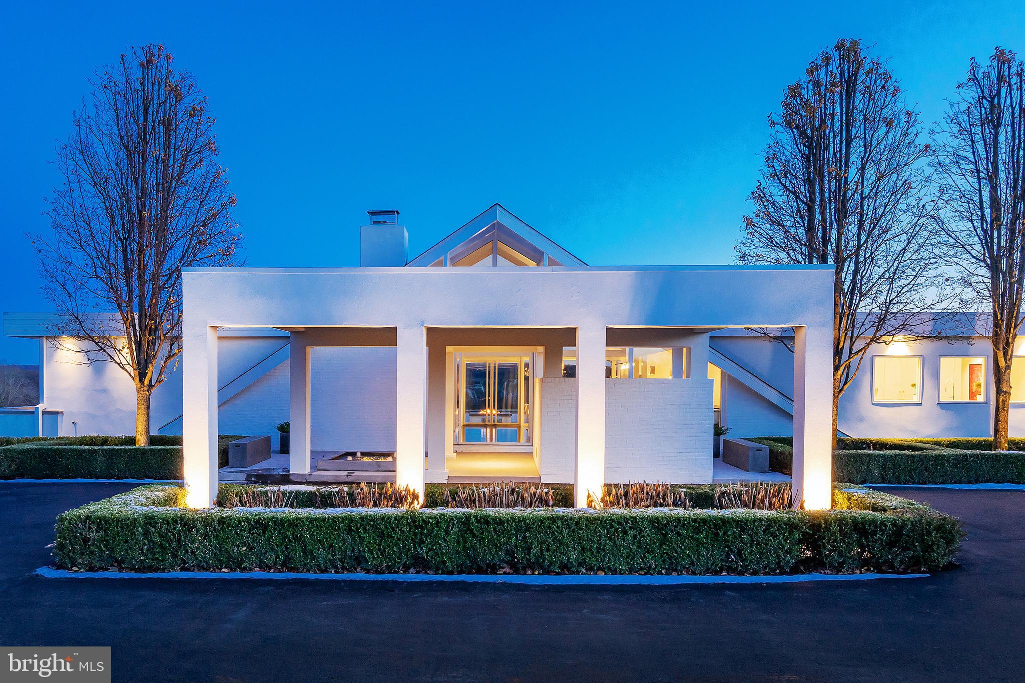 Notable for its rarity, pedigree and quality, this Jules Gregory-designed, Mid-Century Modern residence is like no other home in Bucks County. With more than a passing resemblance to the Swiss Miss A-frame houses of Palm Springs, this 1958 brick and glass house is a pioneering design for our area, exciting and dramatic, sophisticated and serene. Wrapped in glass and overlooking hundreds of acres of preserved Buckingham Township farmland, this residence has undergone a careful expansion and 360-degree renovation overseen by professional designers who worked their magic to turn it into a sexy chalet-esque house that embodies their philosophy of clean, crisp, comfortable modern. This is not your parents Mid-Century house. The designers integrated quality fixtures and finishes along with incredibly smart space planning. Strikingly white with gloss-black hardwood floors, the interiors exude clean simplicity. An open floor plan prevails in the original core of the house with rooms designated by seating areas, a fireplace, lighting, and a wet bar with custom cabinetry, all under a vaulted ceiling with a wall of glass and those magnetic views. This is, as photographer Slim Aarons might say, the sort of home one might imagine attractive people doing attractive things in attractive places. The kitchen is in the heart of the house. Chef s and those who prefer to hire them will want for nothing with a 16 foot island, custom cabinetry everywhere, two of everything in the way of Wolf, Bosch and Sub-Zero appliances, a polished stainless steel ventilation hood and Quartz countertops finished with waterfall edges. The kitchen is open to the family room, yet another carefully considered space lined in windows, welcoming with generous seating, a fireplace, custom shelving and an office area with custom desks that blend perfectly with the home s aesthetic. True to one of Mid-Century Modernism s core ideas, all of these rooms access a rear patio. There, a bar, barbecue area, built-in firepit and plenty of seating here and by the pool accommodate warm-weather gatherings. Private guest quarters include two en suite bedrooms at one end of the house, both with all-new Quartz and marble bathrooms, walk-in closets and other amenities. The main bedroom suite is designed to be closed off from the more public areas of the house. Soak in the tub while taking in a stunning country view; an oversized walk-in shower is finished in bookmatched Quartz slabs; the custom double vanity has many extra features built in. The dressing room and closet are the size of a small boutique and provide excellent storage. The bedroom itself accesses the rear patio and so enjoys the prized view. Power drapes here and in all of the bedrooms create total darkness and privacy. Created by designers for designers, this Modernist gem overwhelms with a long list of amenities best experienced in person. Some of the most critical include a whole-house generator; a 2+ car garage with additional storage; a deluxe laundry room; whole-house audio that extends outside to both the front and back of the house; custom storage throughout; custom lighting; nine skylights; water features along the front fa ade and a location with classical Bucks County views.Please check the link for the Matterport 3D tour in the photos and video section. This will allow you to take a tour, site unseen, of this stunning Masterpiece!! VIDEO