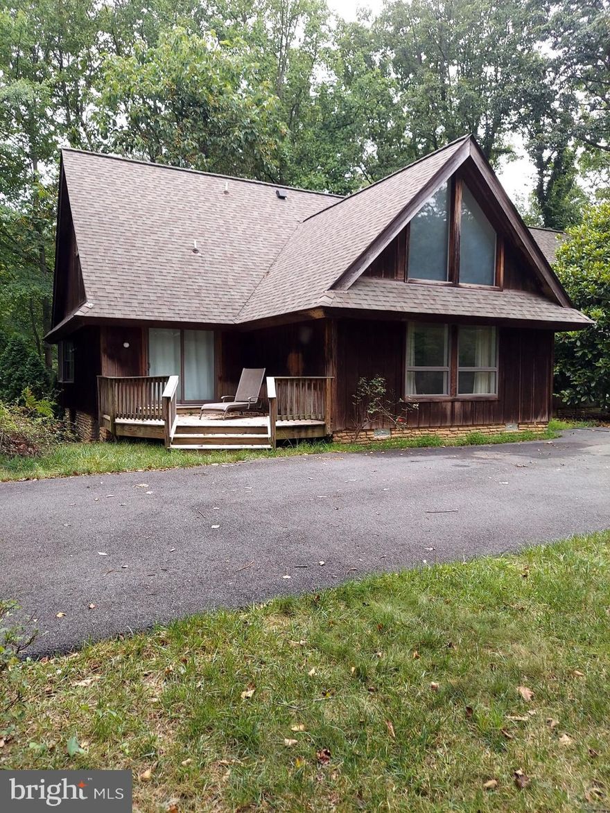 This is a rare opportunity to own a wooded 1.84 acre  Home/Lot in Vienna, just off Lawyers Rd and set on a small cul-de-sac with 7 homes. There is so much potential! This property has an existing three-level home that can be renovated or removed to build your dream home. The existing 5 bedroom 4 bath house is fully habitable with hardwood floors on the main level, with a full working kitchen, a 5-year-old roof, and a 1.5 yr old HVAC system on the lower level.   This property, set on a large lot with gorgeous wooded views from the back of the house, is a dream come true for someone looking for a home with main-level living with huge potential. The house has a large, fully finished walk-out basement with a fireplace with a wood-burning insert, an extra bedroom, and a bath. The property is being sold “As-Is”.  All kitchen appliances, including clothes washer and dryer are operational. Private 220' well  & conventional septic. Bring your builder, architect or contractor to determine your perfect house design to best enjoy the woods and views. Schedule a showing and come take a look at what may be your diamond in the rough. Plenty of woods and a large flat front  yard space for relaxing activities for those who love the outdoors. Hunters Station Road is a small quiet, non-thru street with No HOA. The convenient location is close to shopping and transportation hubs: Reston Town Center and the Town of Vienna; walking/biking distance to the Wiehle Metro Station (2 miles); driving distance to the Vienna Metro Station (3 miles); biking distance to the WO&D trail (1 mile); walking distance to restaurants and shopping (South Lakes); short drive to Dulles Airport and Tysons Corner (15 min)