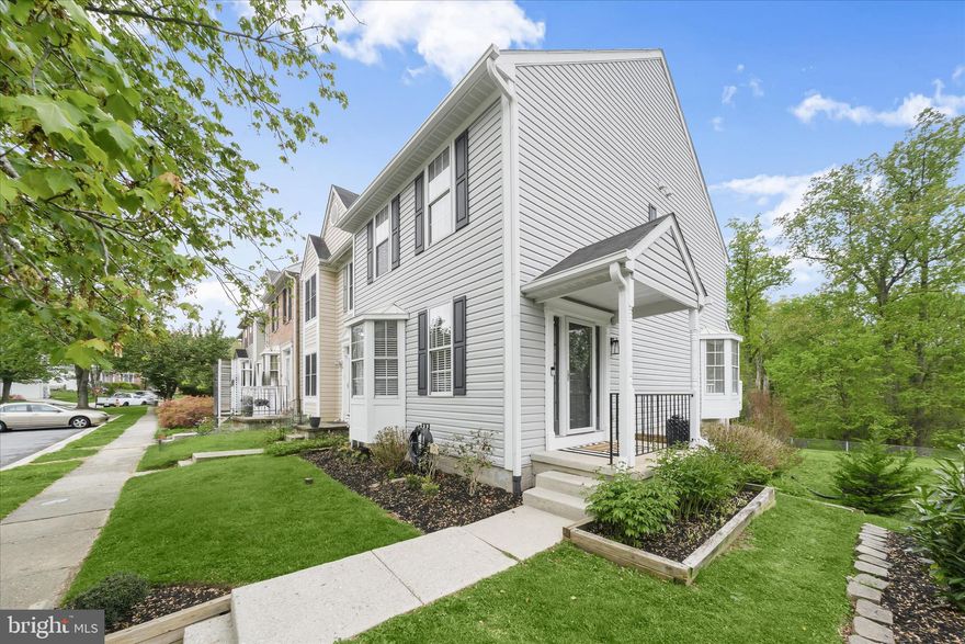 Spacious end-of-row home in sought-after Patapsco Falls community, thoughtfully updated for modern living. Recent improvements include the kitchen, lighting, sliding doors, water heater (2021), cordless blinds (2025), hardware, flooring, and more. A covered entry welcomes you to an open floor plan with generous living and dining areas, highlighted by a stylish chandelier and hardwood flooring in the dining space. The expansive kitchen features a sun-drenched breakfast room, white cabinetry accented with black hardware, beautiful quartz countertops, stainless steel appliances, and a sliding glass door that opens to the oversized deck, perfect for everyday living and entertaining.  Upstairs, all bedrooms boast sweeping vaulted ceilings. The primary suite offers a walk-in closet and a private en suite bath complete with a soaking tub, separate shower, and quartz-topped vanity. Two additional bedrooms and a hall bath complete the upper level.  The finished lower level provides a spacious family room with sliding door access to a brick patio overlooking a tree-lined view, along with a half bath and a large storage and utility room. Ideally located near major commuter routes with abundant shopping, dining, and entertainment options nearby, this home combines comfort, style, and convenience.