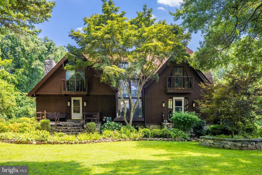 Private Woodland Retreat on Nearly 2.5 Acres with Indoor Pool & Guest Apartment

Set on nearly 2.5 acres of mature trees and landscaped gardens, this secluded estate offers unmatched privacy and year-round beauty. Outdoor highlights include ponds, stone patios, a pergola, screened porch, fire pit, BBQ grill, greenhouses, a playhouse, and a detached two-car garage with carport and a one-bedroom apartment above.

The main home blends rustic charm with resort-style amenities—vaulted beamed ceilings, skylights, stained glass accents, and Juliet balconies. At its center is a spectacular indoor pool with stone waterfall, hot tub, and sauna. The main level features a dramatic stone fireplace, redwood kitchen countertop, bar, and dining areas. Upstairs offers a library/office, guest room, and a two-story owner’s suite with spa bath. The lower level adds a recreation room, two dens, large bath, and direct patio access.

With abundant amenities, distinctive architecture, and a rare combination of indoor luxury and outdoor beauty, this property is truly one of a kind.