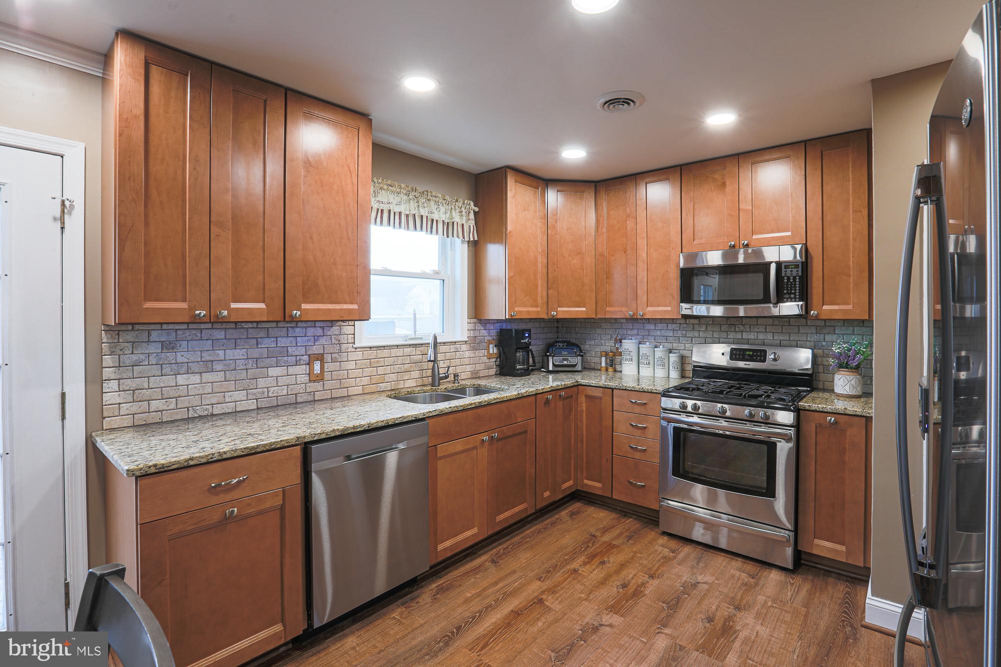 Pride of ownership shines throughout this well maintained all brick home! Enjoy company and entertain on the rear deck leading to your stone patio with built in fire-pit! The spacious backyard is fully fenced and includes a multiple use concrete pad. Do you like to cook & bake? You're all set in the recently remodeled kitchen with 36" cabinets, tile backsplash, granite counters, tons of storage, recess lighting, updated appliances, wine fridge and so much more! The lower level family room is ideal to watch the big game and is highlighted by custom built-ins, bar, pellet stove and updated full bathroom. Other upgrades include: Roof is 4 years old, newer water heater, replacement windows, updated main level bathroom, updated fixtures, crown molding and the list goes on. This home is a true turnkey, make your appointment today!