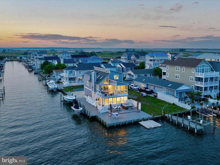 Welcome to your coastal dream retreat—completely renovated and thoughtfully designed to deliver the ultimate waterfront lifestyle. This stunning 4-bedroom, 3.5-bath home boasts over 3,200 square feet of sophisticated living space with jaw-dropping views of the Assawoman Bay from both the main and upper-level decks. 
Perfectly positioned just minutes from the shops, restaurants, and sandy shores of Fenwick Island, this home combines serene waterfront living with the convenience of coastal town life. Spend the day on the beach, explore the local dining scene, or take a quick cruise from your backyard to the open bay—this location offers it all.
Every detail has been elevated, from the new bulkhead running along the side and back of the property to two private boat lifts and dual jet ski floating docks that make launching straight into the lagoon effortless. After a day on the water, unwind in the hot tub while soaking in panoramic sunset views over the bay.
Step inside to a chef’s kitchen built for entertaining—highlighted by a striking wine wall, ideal for showcasing your most prized bottles. Vetrostone countertops lend a sleek, modern edge, while high-end appliances and finishes ensure form meets function.
Each room features professional-style décor with magazine-worthy touches that blend luxury, comfort, and coastal charm. Whether you're hosting a gathering or enjoying quiet moments on the deck, this home offers the perfect setting to start making unforgettable memories.
This is more than just a house—it's a waterfront lifestyle waiting to be lived. 
As it is being sold furnished, just bring your bags and toothbrush!
