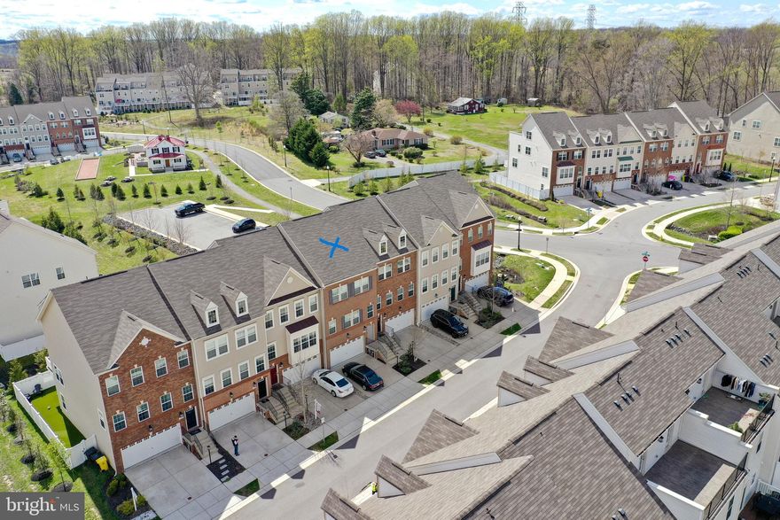 Beautiful 3 Level 2 Car Garage Townhouse in the sought area of Gambrills in the community of Summerfield Village, 2,772 Total Sq Ft per tax records. This home has had only one owner and is less than 6 years old and very well maintained. You will love the Open-Concept Main Level that features amazing Knotted Chestnut Mohawk Wood Flooring in the Family Room, Dining Area and Upgraded Gourmet Kitchen w/ Elegant Dallas White Granite Countertops, Electrolux Stainless Steal Appliances, 5 Burner Gas Cooktop w/ Vented Hood to Exterior, Over-Sized Walk-In Pantry, Wall Oven, Granite Island w/ Storage and Power to plug in your Crockpot/Instant Pot or Griddle in the Morning. The Kitchen also boost plenty of Storage w/ Sleek Stone Color Cabinets, Recessed Lighting, plus Breakfast Bar w/ Pendant Lighting and Stools Seating. Just off the Kitchen and Pantry is a Coffee Bar w/ Wine Rack, Half Bath w/ Pedestal Sink and a Slider to a Large Composite Deck.  The Upper Level includes 3 bedrooms, 2 Full Bathrooms and your Laundry Closet all on the same Level, no need to carry laundry baskets up and down the stairs, huge bonus!! The Primary Bedroom has an En-Suite, Plenty of Natural Light w/ 3 Windows, Large Walk-In Closet w/ Window and Crown Molding. The Primary Bath includes; Granite Counter Top w/ Double Sinks, Ceramic Tile Flooring, Water Closet and Shower Stall w/ Tile Surround. The Hallway Full Bath has a Shower/Tub Combination w/ Tile Surround & Flooring. The Lower Level has a Rec Room w/ Full Bathroom w/ Shower, Granite Countertop and Tile Flooring. The Rec Room is fully Carpeted and has a Slider to the Backyard w/ an area of Grass for that new Puppy or household Pet.  Additional Items to Mention, the Garage has a Storage Closet, Driveway Fits 2 Cars, Entry Foyers Main and Garage has the same Knotted Chestnut Mohawk Wood Flooring as the Main Level, Heating/AC w/ Smart Thermostat and 2 Coat Closets One Main Level the Other near Garage Entry. This home is conveniently located w/ a pathway to Waugh Chapel Towne Centre which includes Restaurants, Cafes, Shopping options including Boutiques as well as a Large Retail Stores, Movie Theater, Banks, Grocery Stores, Wine Bar, Pubs a Gym and much more... The location is idea for commuting to Annapolis, DC, Baltimore, Fort Meade and NSA. The Community Amenities Include, Community Clubhouse, Dog Park, Jog/Walk Paths and Tot Lots/Playgrounds. Looking for a very well maintained and loved home that is move-in ready this is the one, schedule your Appt ASAP, this one will go quickly.