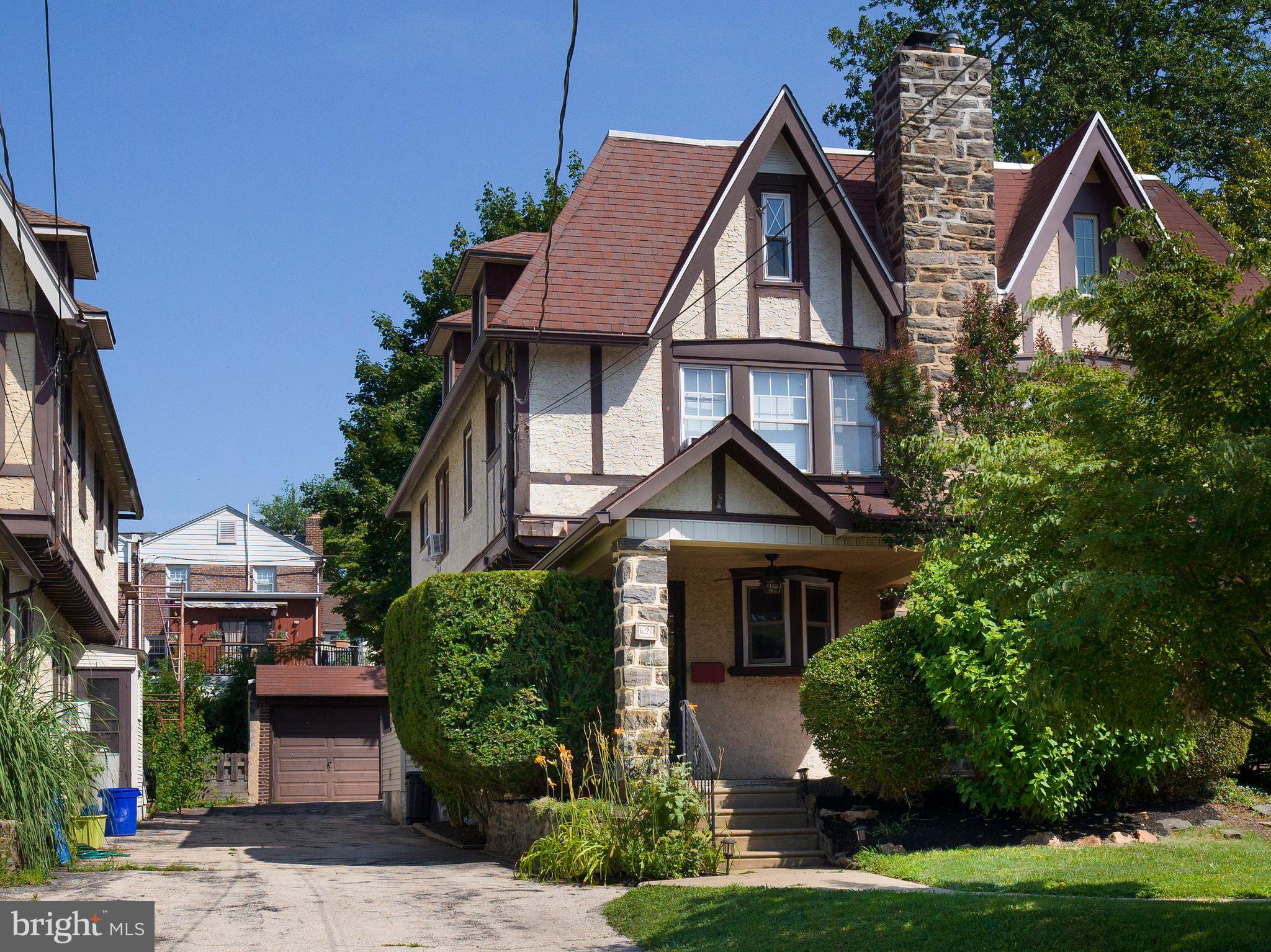 Gracefully positioned on a tree-lined street in the highly regarded Chesnutwold Elementary catchment, this elegant Tudor-style Ardmore residence offers over 2,500 square feet of thoughtfully designed living spaces across all four levels of this expansive home.
From the first step onto the covered front porch, framed by stately stone pillars, you’re greeted by a sense of timeless grace— you’ll feel the allure of this home’s historic character—enhanced by original hardwood floors, classic architectural details, and refined modern updates.
Inside, a sunlit living room with a classic wood burning fireplace, a spacious formal dining room, and a beautifully updated eat-in kitchen with stainless appliances, granite countertops , double sinks and pantry—perfect for casual breakfasts and snacks.
Upstairs, on the second floor you'll find three spacious bedrooms and a newly updated modern full bath with sleek tile and clean, updated finishes. But it's the third floor bonus suite that truly sets this home apart—complete with its own bedroom, full bath and living quarters, this floor offers flexible space for every lifestyle. Whether you're welcoming an au pair, hosting guests, or creating the ultimate playroom, this bonus level provides privacy and possibility. The finished lower level adds even more room to spread out—ideal for a media space, home gym, hobby room, or tucked-away office.
Out back, a wood deck opens to a lush, level lawn—an ideal setting for garden parties, playtime, or serene evening unwinding. A detached one car garage with added storage space and long driveway offer off-street parking for multiple cars—rare and valuable in this area.
This home is a rare blend of space, charm, and location.