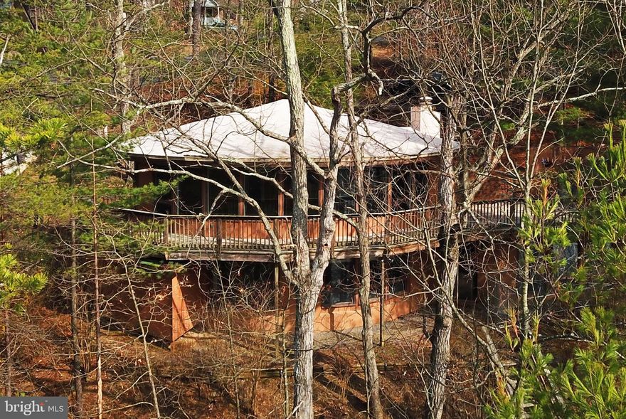 LIVE AT THE LAKE! SPECTACULAR WATERFRONT HOME WITH WATER VIEWS AND DOCK. Unique contemporary on lovely wooded lot. Gated community near Winchester and 90 minutes from the beltway. Enjoy all that Lake Holiday has to offer - beaches, swimming, boating, fishing, water skiing, dog park, walking trails, clubhouse with exercise room, playgrounds and basketball, tennis and volleyball courts. The property is on a wide finger, just off the main body of Lake Holiday. One-third acre wooded lot with 82 feet of lakefront. Great place for entertaining both indoors and outdoors. Large deck overlooking the water and a dock on the lake. Spacious, dramatic great room plus basement family room.  4 bedrooms, including one on main level. Walkout basement. Heat pump for heating and cooling plus baseboard electric heat. Circular driveway.  Landlords pay HOA fee. VR lease and tenant consent form required for all tenants and guarantors. Application fee $45 each. Lister to run reports, write lease. No smoking. Pets considered case-by-case.  Landlords prefer tenants with credit scores of 680+ and monthly income of at least 3x the rent. Minimum 1-year lease but 2 years preferred. Owners/agents. Fireplace and wood-burning furnace are not for tenant's use. Square footage, lot size, water frontage approximate.