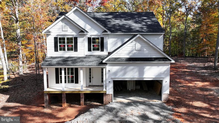 Introducing a brand-new lakeside lifestyle in Bluewater at Lake Anna with a December delivery— where Danaf Homes proudly presents the Monteray III: an elevated blend of refined craftsmanship, timeless design, and water access that gives you the freedom to boat, swim, paddle, and simply breathe deeper. This thoughtfully designed 2-story home features 3 bedrooms + loft, 2.5 baths, and spacious open-concept living, offering room to relax, entertain, and fully embrace the lake life. Step inside and feel the bright, airy flow of upgraded LVP throughout the main floor, including the dining room, great room, kitchen, foyer, mud room, and more, while neutral, plush carpet keeps the upstairs bedrooms cozy and calm. A stunning chef’s kitchen steals the spotlight with white cabinetry topped with crisp crown molding, quartz countertops, matte black hardware, stainless Whirlpool appliances, and a white apron-front Kohler farmhouse sink — modern style with luxurious functionality. A gas fireplace anchors the great room with designer slate surround and mantel, creating the perfect atmosphere for gathering after lake adventures. The primary suite offers a true retreat with a soaking tub, tiled walk-in shower with matte-black framed glass, quartz vanity, and upgraded mirrors for polished elegance. Secondary baths and powder room continue the elevated features with quartz, Delta matte-black fixtures, and stylish lighting selections throughout. Outside, classic curb appeal takes centerstage with Colonial White + Granite Gray siding, designer shakes, black shutters, charcoal shingles, and matte-black exterior lighting, giving the home a clean, modern coastal vibe. A keyless entry garage opener and upgraded hardware provide daily convenience, while low-maintenance finishes allow you to spend less time working and more time soaking in the lake life. Located in the coveted Bluewater community — known for its deep-water access, private boat ramps, and beautiful shoreline — this home puts you minutes from Lake Anna Winery, local marinas, dining by boat, and endless opportunities to chase sunsets. This is more than new construction — it’s a new chapter. A place where weekends turn into vacations, neighbors become friends, and every sunrise reminds you: you did something right. The Monteray III at Bluewater delivers the luxury you crave, the location you dream about, and the lake life you deserve.