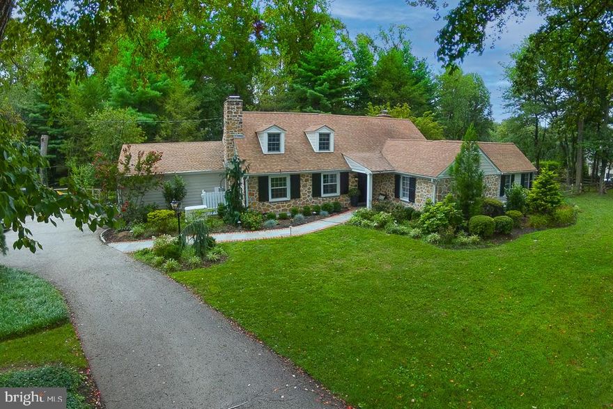 Welcome to 1119 Waverly Road, a beautifully updated and meticulously maintained home in the heart of Gladwyne. Set on a serene and level 0.87-acre lot, this 4-bedroom, 2.5-bathroom residence offers 3,387 square feet of elegant living space in the award-winning Lower Merion School District. A classic center hall home entryway welcomes you into the residence, leading to the formal living room featuring crown molding and a cozy gas fireplace. The sizeable living room flows seamlessly into the formal dining room, creating an ideal space for entertaining. The heart of the home is the spacious gourmet kitchen, complete with an oversized center island, quartz countertops, top-of-the-line appliances, abundant storage, and picturesque views of the backyard. Adjacent to the kitchen is a charming breakfast room with Spanish tile floors and exposed beams, opening into the family room with a second gas fireplace, custom built-ins, and direct access to the expansive flagstone patio. A separate space off the family room with additional built-in bookshelves is perfect for a home office or library. A thoughtfully designed pantry/dry bar and access to the 2-car garage adds convenience and organization to daily life. The first-floor primary suite is a true retreat with vaulted ceilings, sliding doors to a private patio, a spacious walk-in closet/dressing room with built-ins, and a luxurious ensuite bathroom featuring a walk-in shower. Upstairs, you’ll find three generously sized bedrooms, a full hall bathroom with tub, and a linen closet for added storage. The finished lower level offers versatile space for a playroom, home gym, or media room, along with a dedicated laundry area and additional storage. Outside, enjoy the expansive fenced-in backyard with a long flagstone patio, including a covered area perfect for outdoor dining and shaded relaxation. The flat, usable lot provides endless opportunities for play, gardening, or future enhancements. Conveniently located just minutes from the charming village of Gladwyne, local parks, and major roadways for an easy commute, this exceptional home combines timeless design with modern comfort in one of the Main Line’s most sought-after neighborhoods.