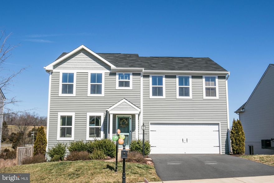 This 4 bedroom home has layout and style in spades!  You're gonna love the kitchens custom cabinetry and farm sink that overlooks a large natural field and farmland.  Custom countertops accent the kitchen perfectly.  Stainless steel appliances add a nice touch.  No detail was overlooked from the main levels half bath to the artisan walk in pantry with additional fridge/freezer space.   The kitchen layout opens directly to the sun-lit family room which is perfect for entertaining.  4 upper level bedrooms with generous closet space, 3 with walk-ins.  Upgraded doors in many areas including the bedroom level laundry room.  All bathrooms have tile flooring for convenience and style.  The basement area has rough in for a future bathroom.   Outside the home is landscaped with mulched hedges.  In the backyard you will find a two tier deck-patio combination with lots of space to enjoy warmer days and summer nights.  A recently purchased tool shed provides space for your lawn equipment, patio chairs, and back yard games.  There truly is a lot to love about this home.