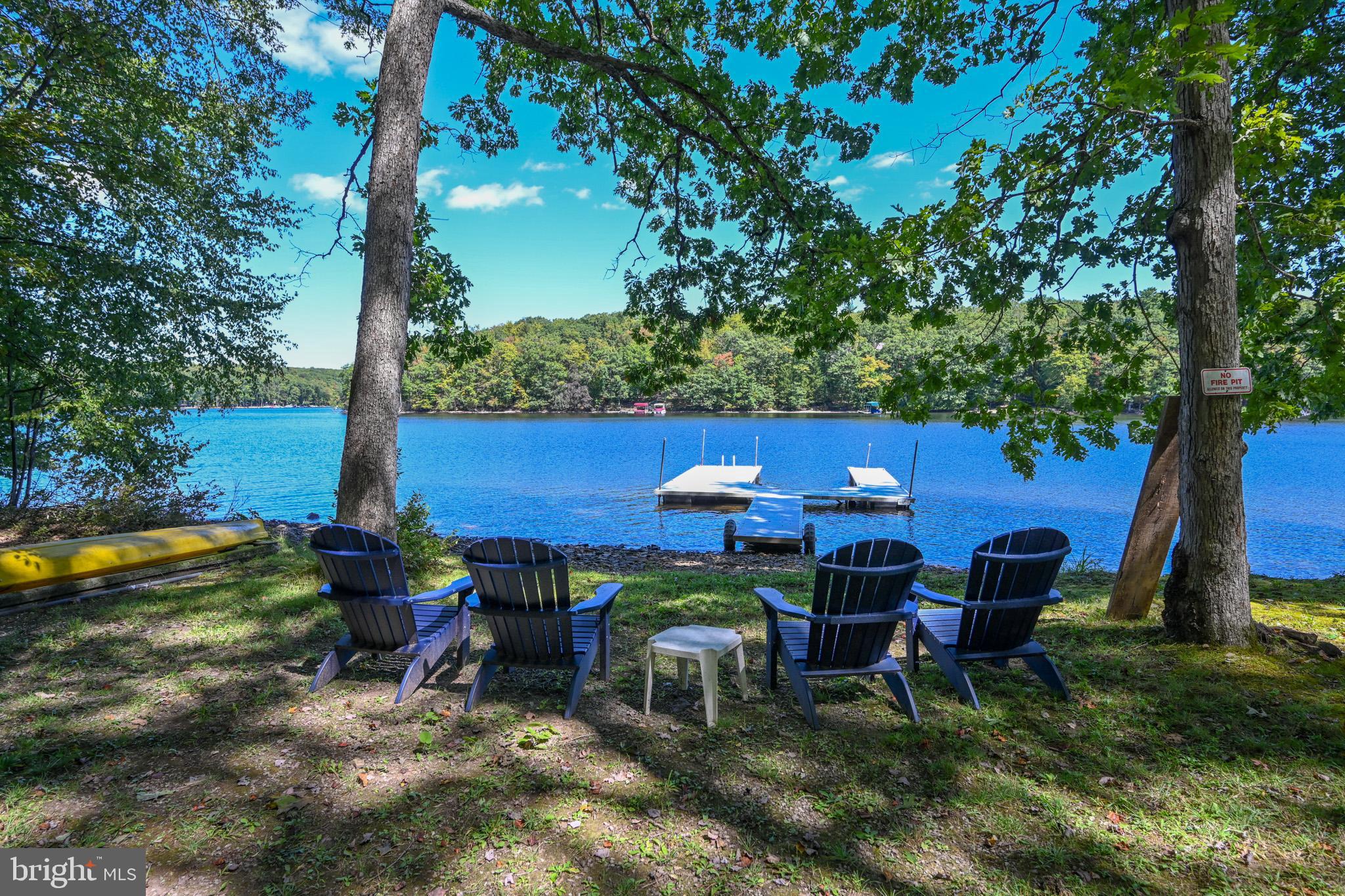 Wake up to a light mist rising over Deep Creek Lake and enjoy level lakefront living with your own private dock at the top of Red Run Cove. This stunning Katahdin Cedar Log Home sits on a quiet cul-de-sac, surrounded by mature trees that create a peaceful canopy. Relax on the expansive TimberTech back deck or unwind in the hot tub on the rear stone patio—all with incredible waterfront views.
Inside, the warmth of pine and hickory fills the home; while soaring ceilings and walls of glass bathe the interior in natural light. Designed for entertaining, the open layout flows seamlessly to the lakefront deck. The home features 5 bedrooms, including a main-level primary suite, and 3.5 baths—with two recently renovated. Additional highlights include a new gas linear fireplace in the family room and beautifully updated finishes throughout.
Located just minutes from Deep Creek’s top amenities—parks, hiking and biking trails, restaurants, golf, fitness centers, and Wisp Resort skiing—this property offers the best of every season.
With its blend of authentic log home craftsmanship, modern updates, and prime lakefront setting, this is the perfect Deep Creek Mountain Escape.