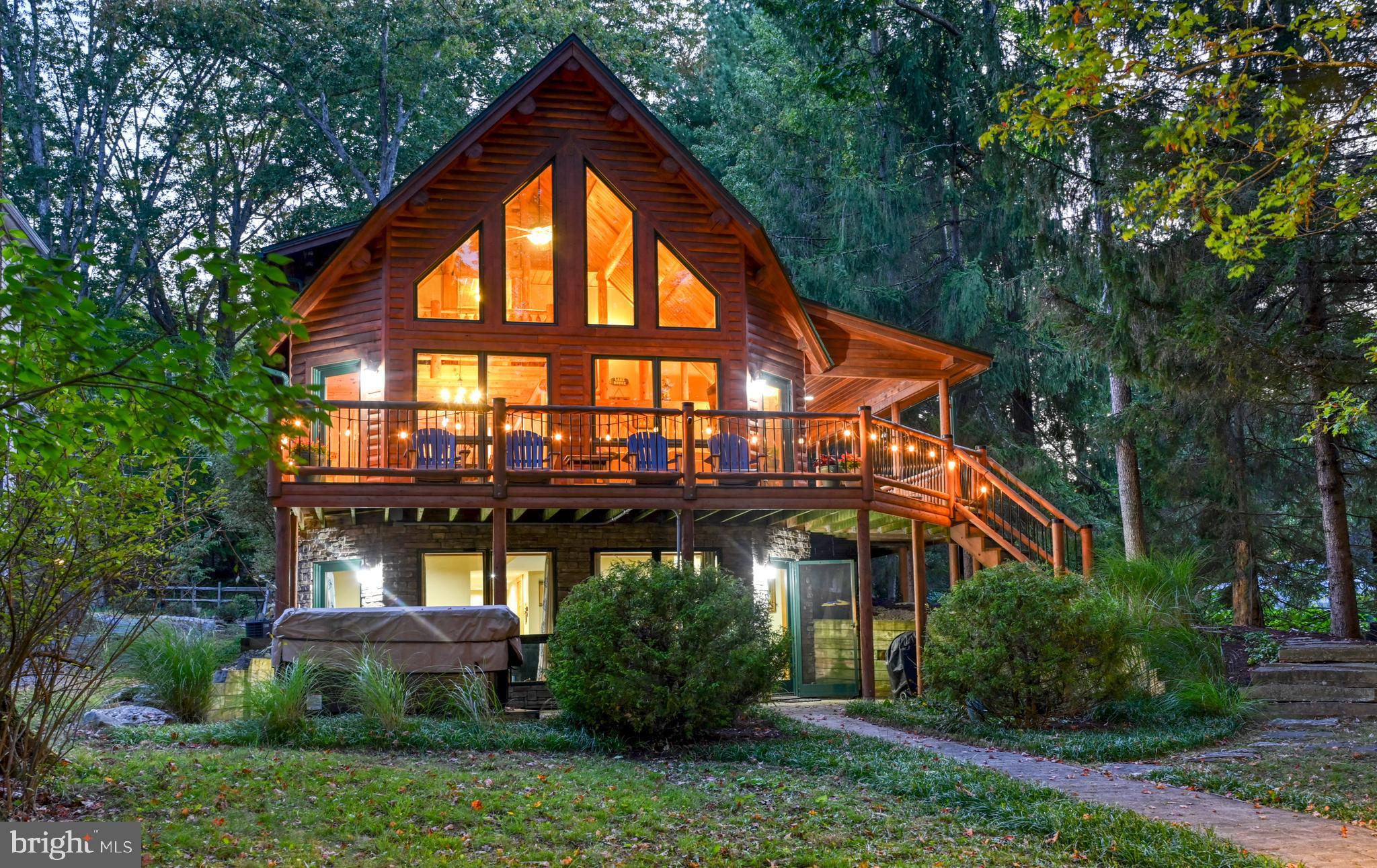 Wake up to a light mist rising over Deep Creek Lake and enjoy level lakefront living with your own private dock at the top of Red Run Cove. This stunning Katahdin Cedar Log Home sits on a quiet cul-de-sac, surrounded by mature trees that create a peaceful canopy. Relax on the expansive TimberTech back deck or unwind in the hot tub on the rear stone patio—all with incredible waterfront views.
Inside, the warmth of pine and hickory fills the home; while soaring ceilings and walls of glass bathe the interior in natural light. Designed for entertaining, the open layout flows seamlessly to the lakefront deck. The home features 5 bedrooms, including a main-level primary suite, and 3.5 baths—with two recently renovated. Additional highlights include a new gas linear fireplace in the family room and beautifully updated finishes throughout.
Located just minutes from Deep Creek’s top amenities—parks, hiking and biking trails, restaurants, golf, fitness centers, and Wisp Resort skiing—this property offers the best of every season.
With its blend of authentic log home craftsmanship, modern updates, and prime lakefront setting, this is the perfect Deep Creek Mountain Escape.