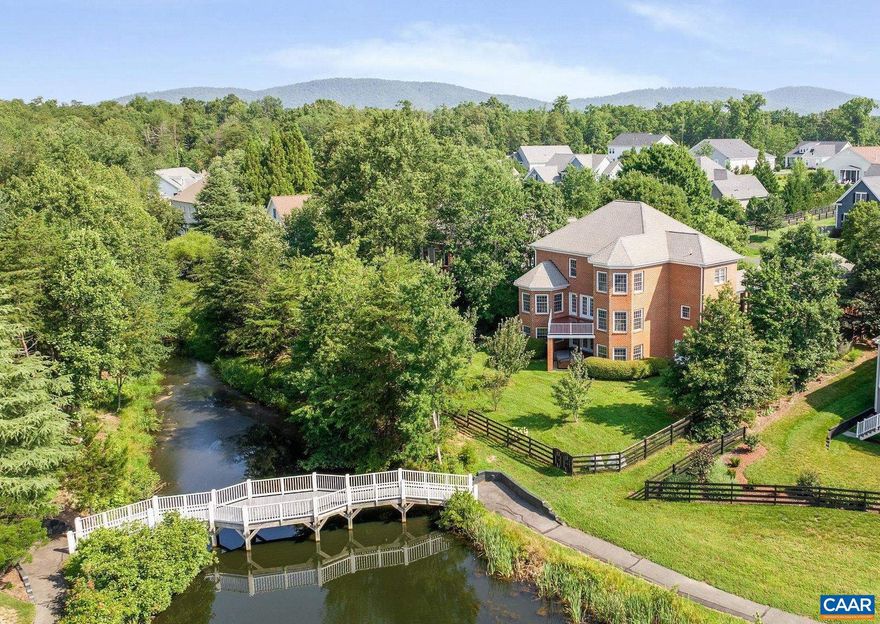 Unique and eco-conscious, this all-brick home offers serene views of Glen Lochan Pond in the heart of Glenmore. With five bedrooms and generous living spaces, it blends classic design with modern comfort. The main level features formal living and dining rooms, a spacious eat-in kitchen with water views, a sunlit family room, and a versatile flex space. Upstairs are four bedrooms, including a large primary suite with a renovated bath. The walk-out basement includes a living area, kitchenette, office, guest bedroom, full and half baths, and access to a six-person Bullfrog spa with ECOsmarte chlorine-free system. The fully fenced yard showcases native pollinator gardens, a small herb garden, fruit trees from Edible Landscaping, and professionally designed landscaping plans from The Natural Garden. Eco features include a rain barrel, garage EV charging, Arcadia Power solar credits, and participation in Envirocycle and Black Bear Composting. Purchasers receive a 25% discount on initiation to the Club at Glenmore.,Fireplace in Family Room