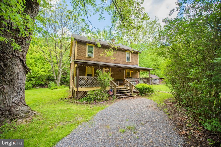 This home is known as The Lady Bug Lodge, was the family home and later the family getaway and a vacation rental. This charming home is on tranquil 1.09 acres. This home has 4 bedrooms and 1.5 baths, plenty of room for family and quest. Has a large front porch and the property backs to the stream, Sir Johns Run. Sit on the large deck or by the fire pit and listen to the water. The Potomac River and the Railroad are very close. It is only 2.5 miles to historic Berkeley Springs with shops, spas, theater, and dining. Home is completely furnished and sold as is.