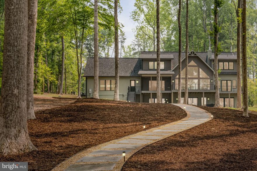 Waterfront Living at Beautiful Lake Anna!  This Stunning 5Bed/6Bath Contemporary Craftsman shows like new and is IMMACULATE!   Built by Local Custom Builder, Spartan Homes!!!   A "Golden Nugget" in Every Way- w/Tons of Upgrades, NEW PAVED DRIVEWAY, NEW HARDSCAPED WALKWAY to Your Very Own Dock, Flat Lot(Almost 1 Acre), LIKE NEW Boathouse and Location, Location, Location!!!  Tucked away on 140' of Private Shoreline,  South of the 208 Bridge on the Public Side.  Step inside this Masterpiece to Breathtaking Water Views and Spectacular Open Floor Plan.   Almost 4500 Sq. Ft. on Two Open Levels, Finished Lower Level w/Kitchenette and 2 Car Garage.  Main Level Features Large Window Wall w/ Pella Windows, Gourmet Kitchen w/Italian Quartz, Massive Island, All S/S Upgraded Whirlpool Appliances: Counter-depth Refrigerator, Large Capacity Dishwasher w/ 3 Racks, Slide in Range w/Gas Cooking & Hood,  Spacious Pantry, Coffered Dining Room Ceiling, Custom Lighting, Cozy 46" Fireplace, Mudroom, Powder Room & Laundry Room.  Main Floor Living w/Ensuite, Walk-in Closet and Deck Access.  Upper Deck Finished w/Upgraded Composite, Metal Railings and Screened in Area.  Upper Level Features: 2 Bedrooms w/2 Full Bathrooms.  Lower Level Features: 2 Additional Bedrooms w/ 2 Full Bathrooms...ALL 5 Bedrooms in Home w/Water Views! Gorgeous Kitchenette on Lower Level w/Additional Family Room and Walkout to Patio & Hot Tub.  A Short Walk to your very own Boat House w/ Maintenance Free Decking, 2 Slips, Electric Lift, Sundeck and Storage Area!  Deeper Water at end of Dock for inboard/outboard Boats & Swimming!  This Home in Anna Vista II is Truly Resort Style Living!  Short-Term Rentals Permitted and Rental Projections Provided.  Comcast Available!!! This Spartan Build home is a Certified Green Home. Green homes are designed and constructed to be healthier, more comfortable, have lower operating costs, be more durable and require less maintenance!!!